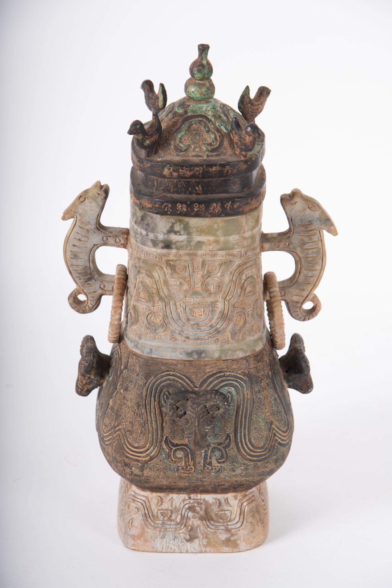 Chinese Jade and Bronze Archaic Style Vessel: Chinese Jade and Bronze Archaic Style Vessel Vessel with four sections of bronze and jade carved with the traditional Taotie mask motif and animal shaped ring handles. Chinese, early 20th Century.