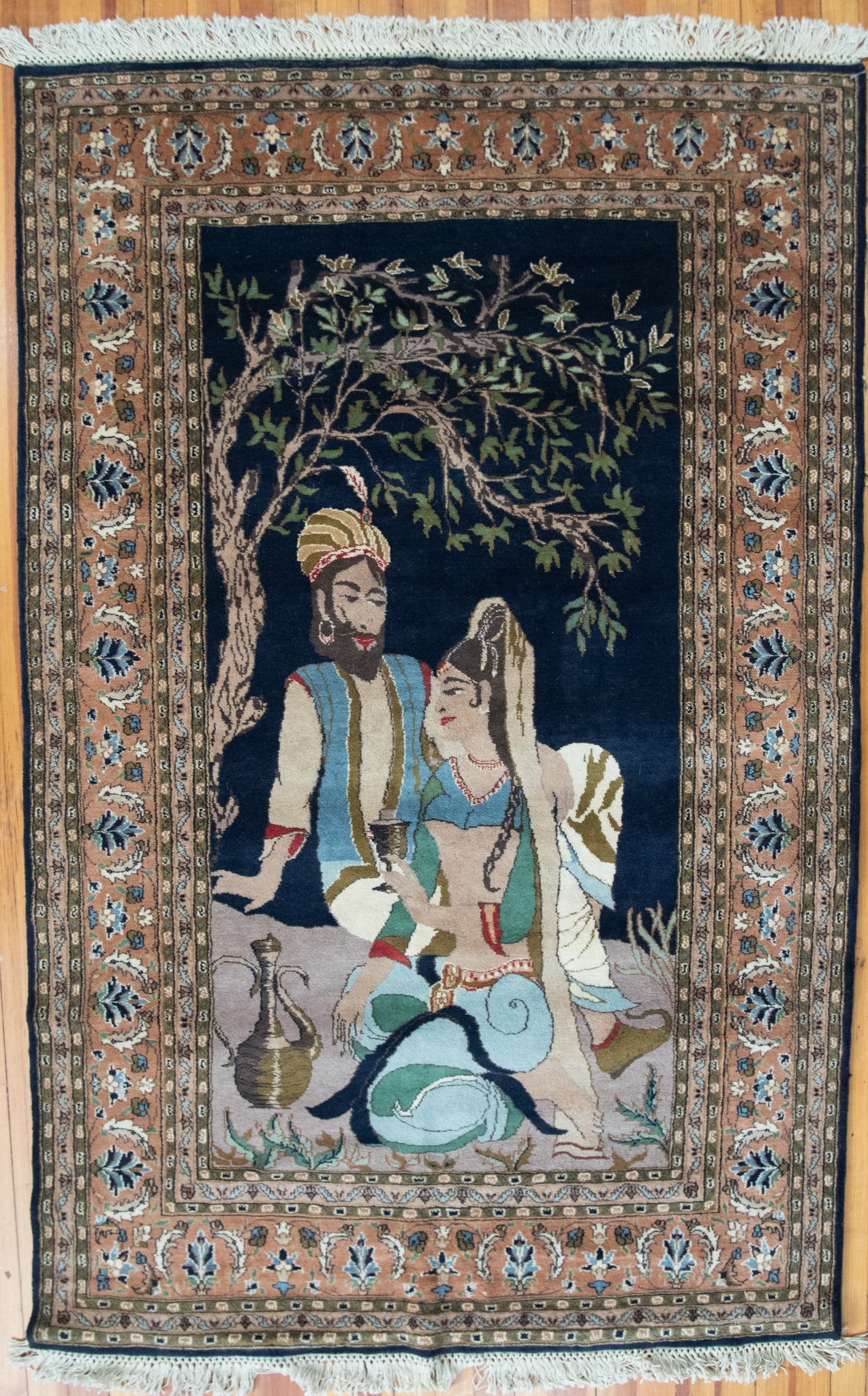 Handwoven Persian Wool Pile Pictorial Area Rug: Handwoven Persian Wool Pile Pictorial Area Rug Showing an exterior scene of a couple seated under a tree with an ewer and floral designs within a primary border and a multitude of guard borders. 4'
