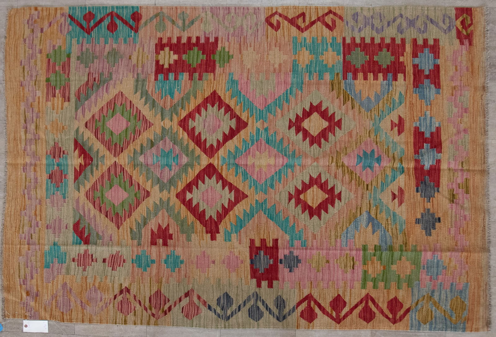 Handwoven Kilim Area Rug: Handwoven Kilim Area Rug Multi tiered diamond and geometric patterns amid a matching border in shades of red, aqua and peach. 4' x 5' 10"