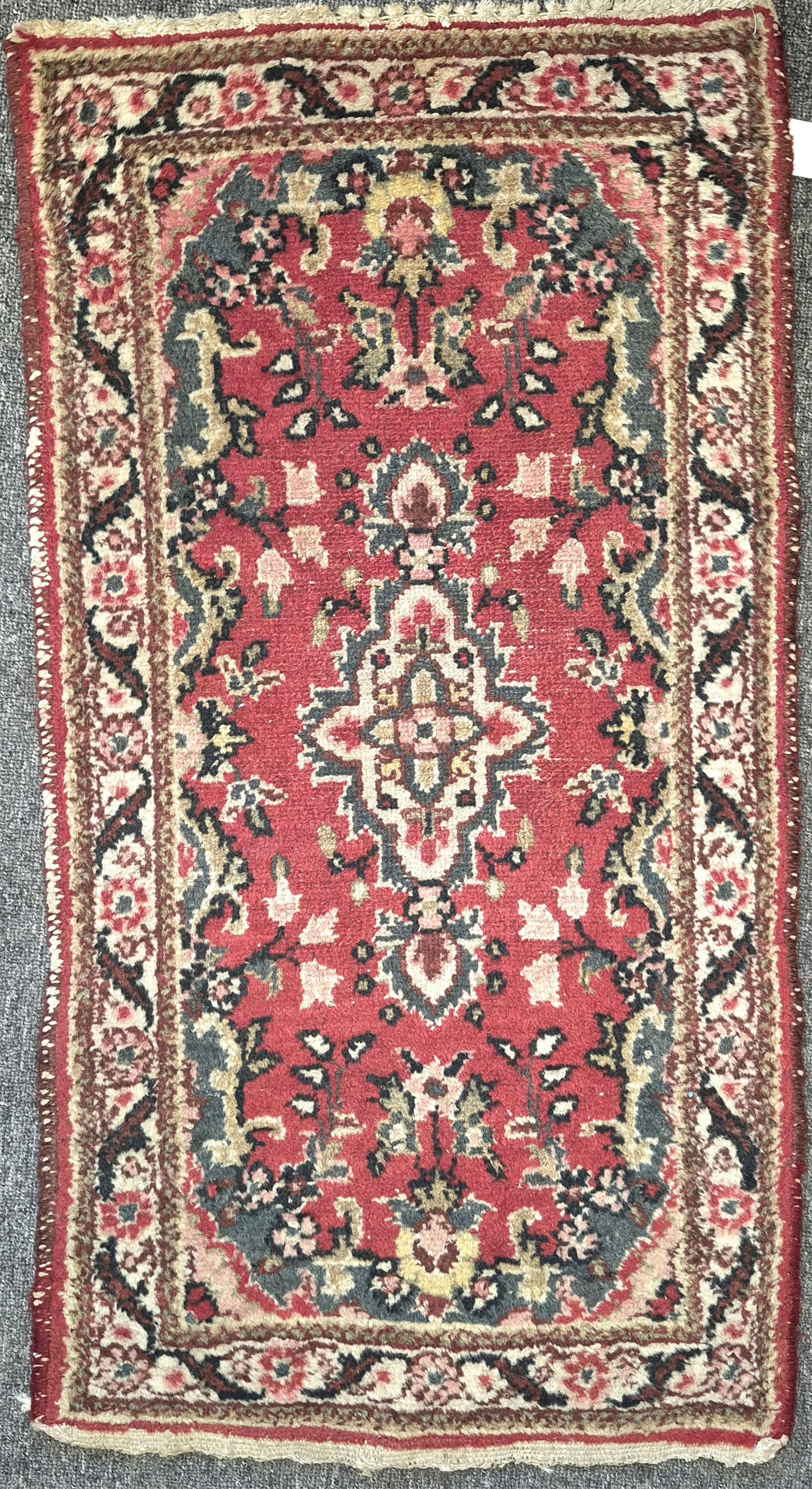 Handwoven Persian Sarouk Throw Mat: Handwoven Persian Sarouk Throw Mat All over floral ornamentation on a wine red field center having a florally decorated primary border centering a pair of guard borders. 2' 1" x 2' 6"