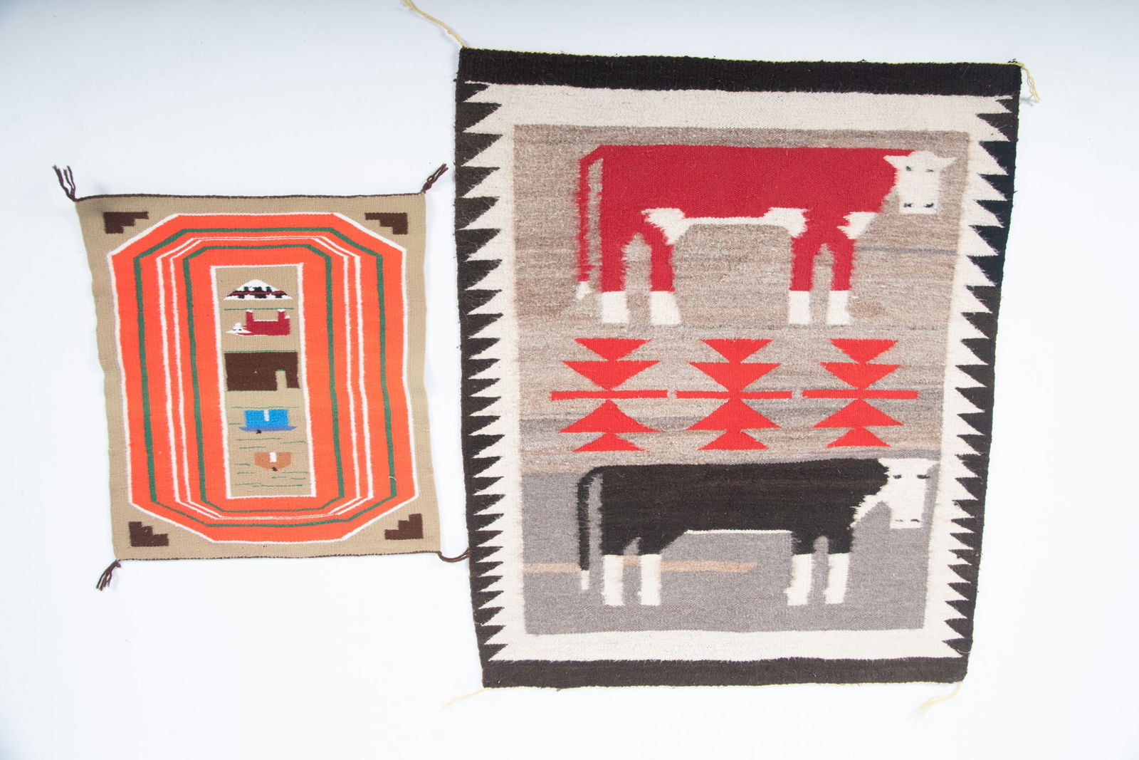 Two Navajo Pictorial Weavings: Two Navajo Pictorial Weavings The larger one with two cows on a traditional geometric background, and the smaller weaving showing houses and a cow. 38 x 31 inches, and 21 x 19 inches