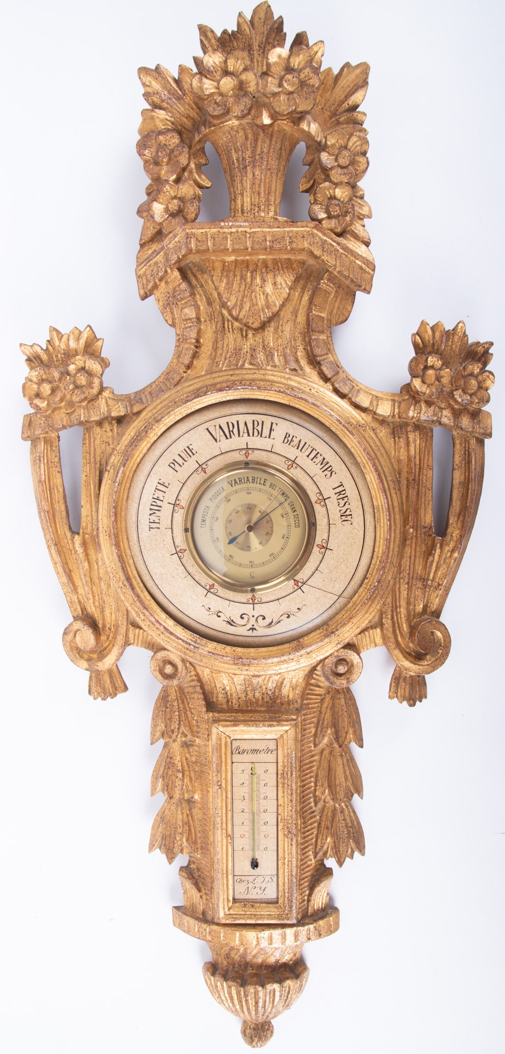 An Italian Carved and Gilt Wood Barometer: An Italian Carved and Gilt Wood BarometerItaly, mid 20th century, a carved wood wall barometer, the Lufft barometer and thermometer housed within a Louis XVI style case.17 x 38 inches
