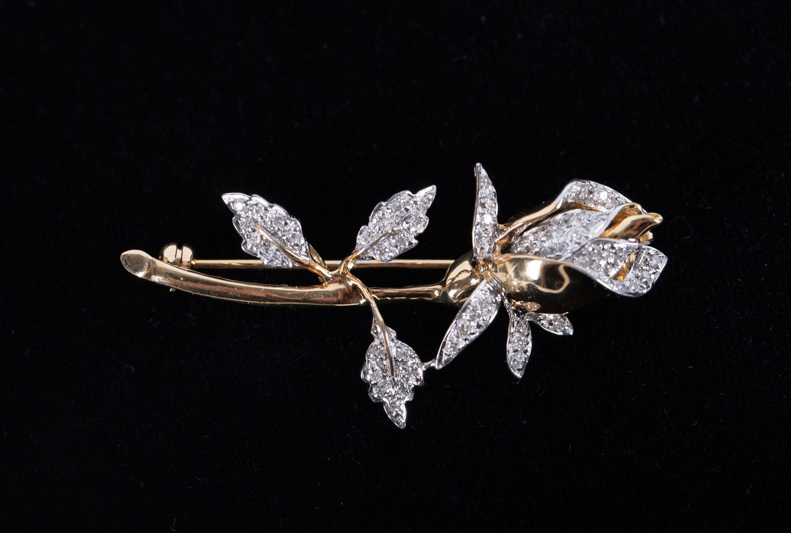 Vintage 14K Yellow Gold Diamond Floral Brooch: Vintage 14K Yellow Gold Diamond Floral BroochThis sparkly floral brooch can also be worn as a pendant. It has approximately .75CTW in diamonds and weighs 8g including stones. It is 1 3/4 inches long.