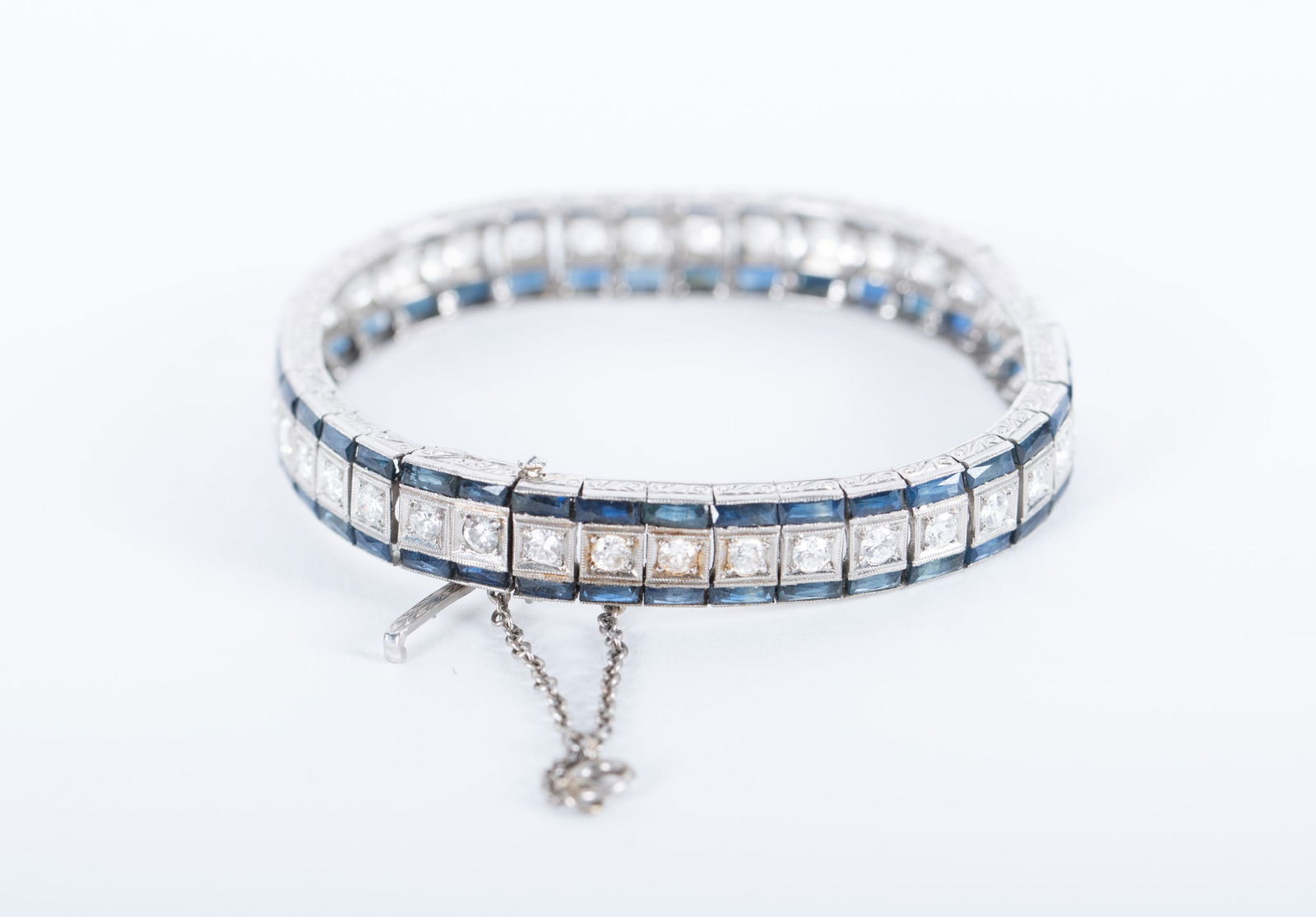 Retro Platinum Diamond and Sapphire Bracelet: Retro Platinum Diamond and Sapphire BraceletThis glorious piece has approximately 3.80 CTW in diamonds and 75 [1 missing, should be 76] baguette sapphires. It tests platinum and the gross weight is 35