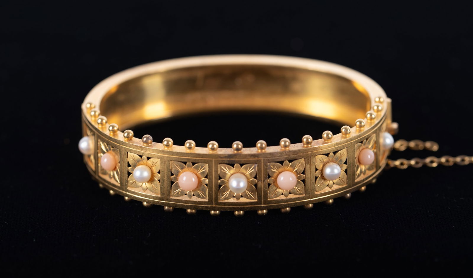 Charming 18K Yellow Gold Bracelet with Coral & Pearls: Charming 18K Yellow Gold Bracelet with Coral & PearlsThis bracelet has a circumference of 6 1/2 inches. Weight including stones is 18.8g. Safety chain needs repair.