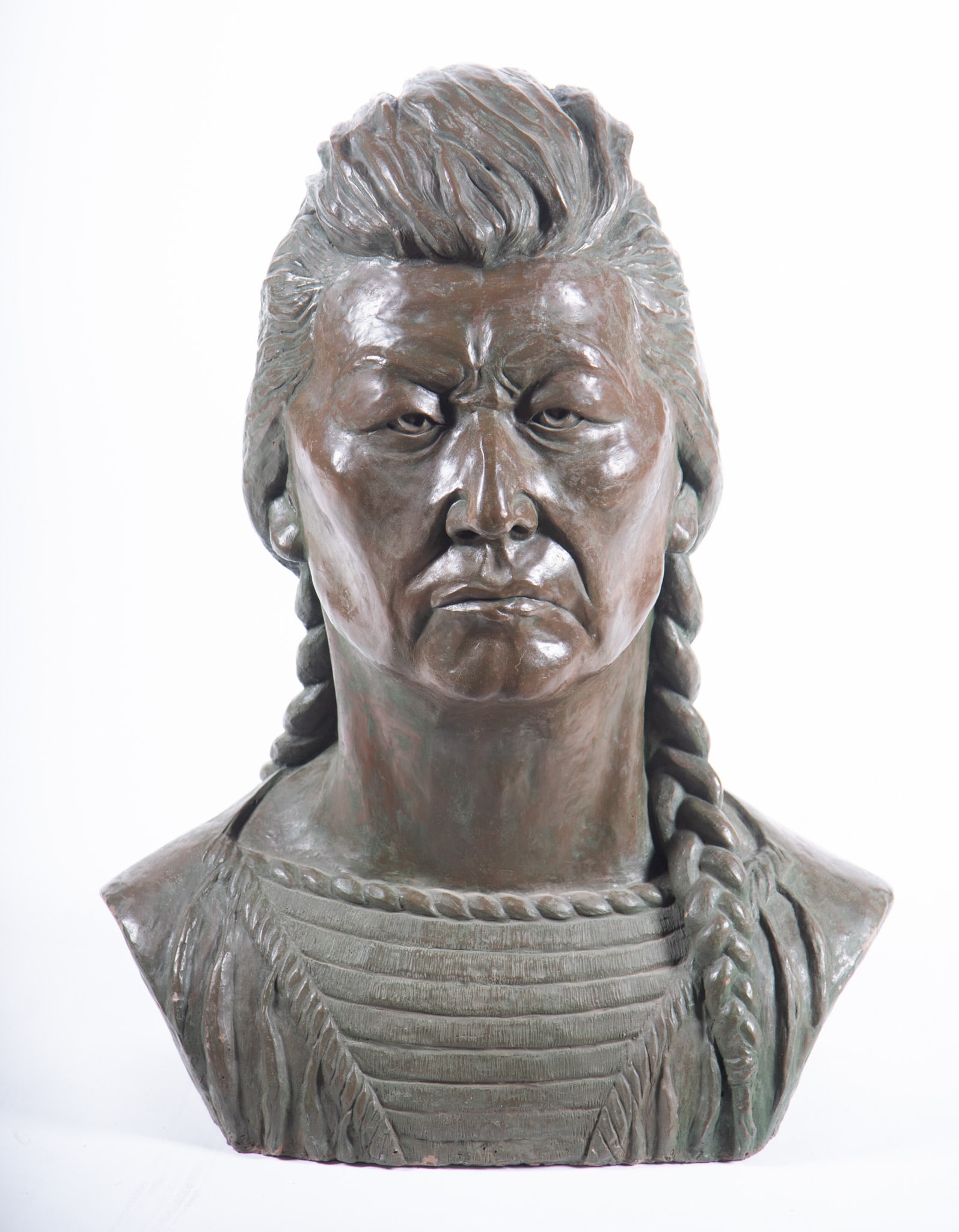 A Monumental Bronze-Clad Sculpture of Chief Plenty Coups by Margaret Evelyn Movius "Dolly" Felt: A Monumental Bronze-Clad Sculpture of Chief Plenty Coups by Margaret Evelyn Movius "Dolly" Felt (1922-2011) A finely sculpted bronze over plaster bust of Chief Plenty Coups with long braids and