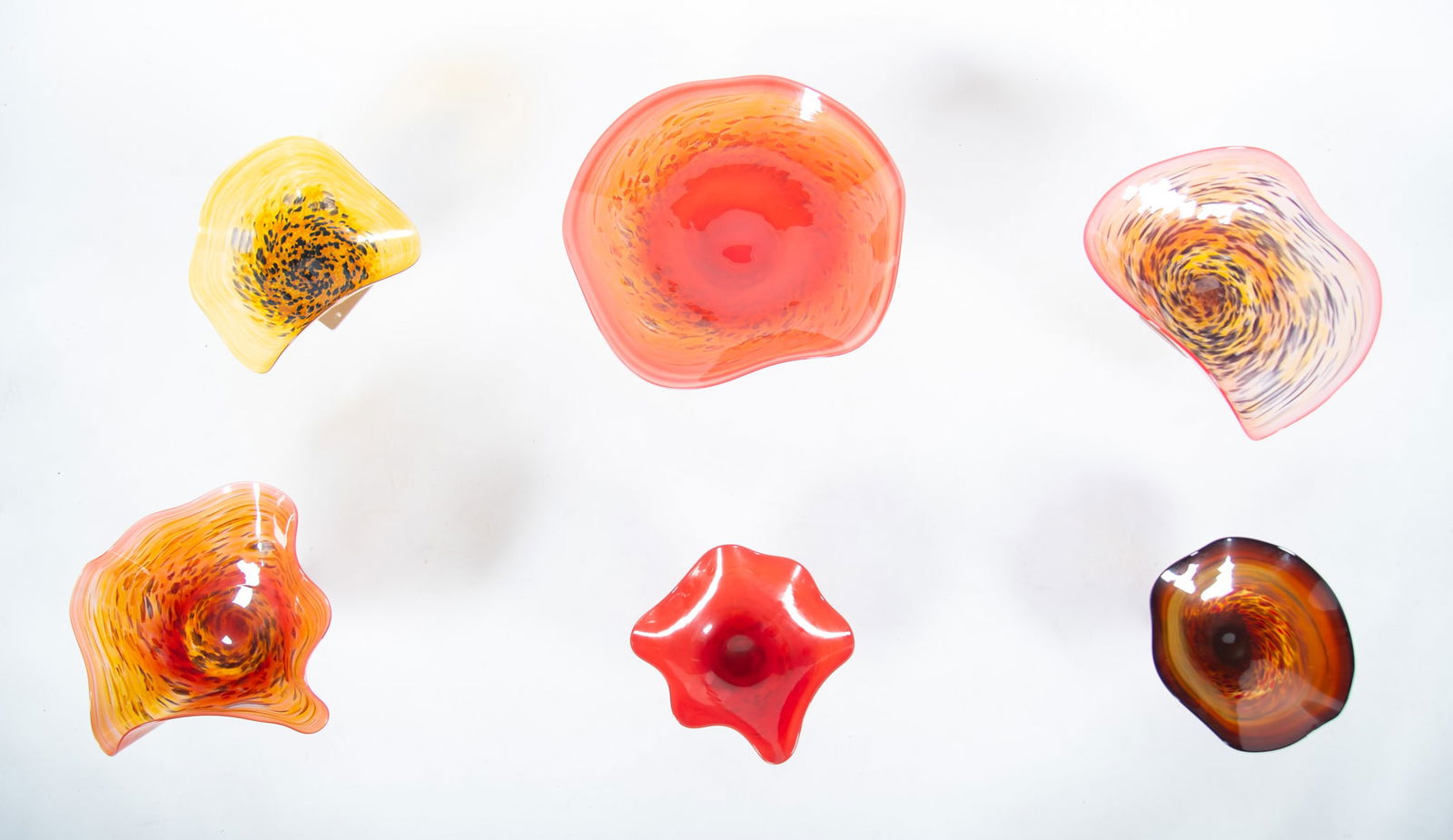 Six Studio Art Glass Wall-Mounted Flowers: Six Studio Art Glass Wall-Mounted Flowers various shades of red and yellow, with wall mounts. Diameter of largest: 18 inches