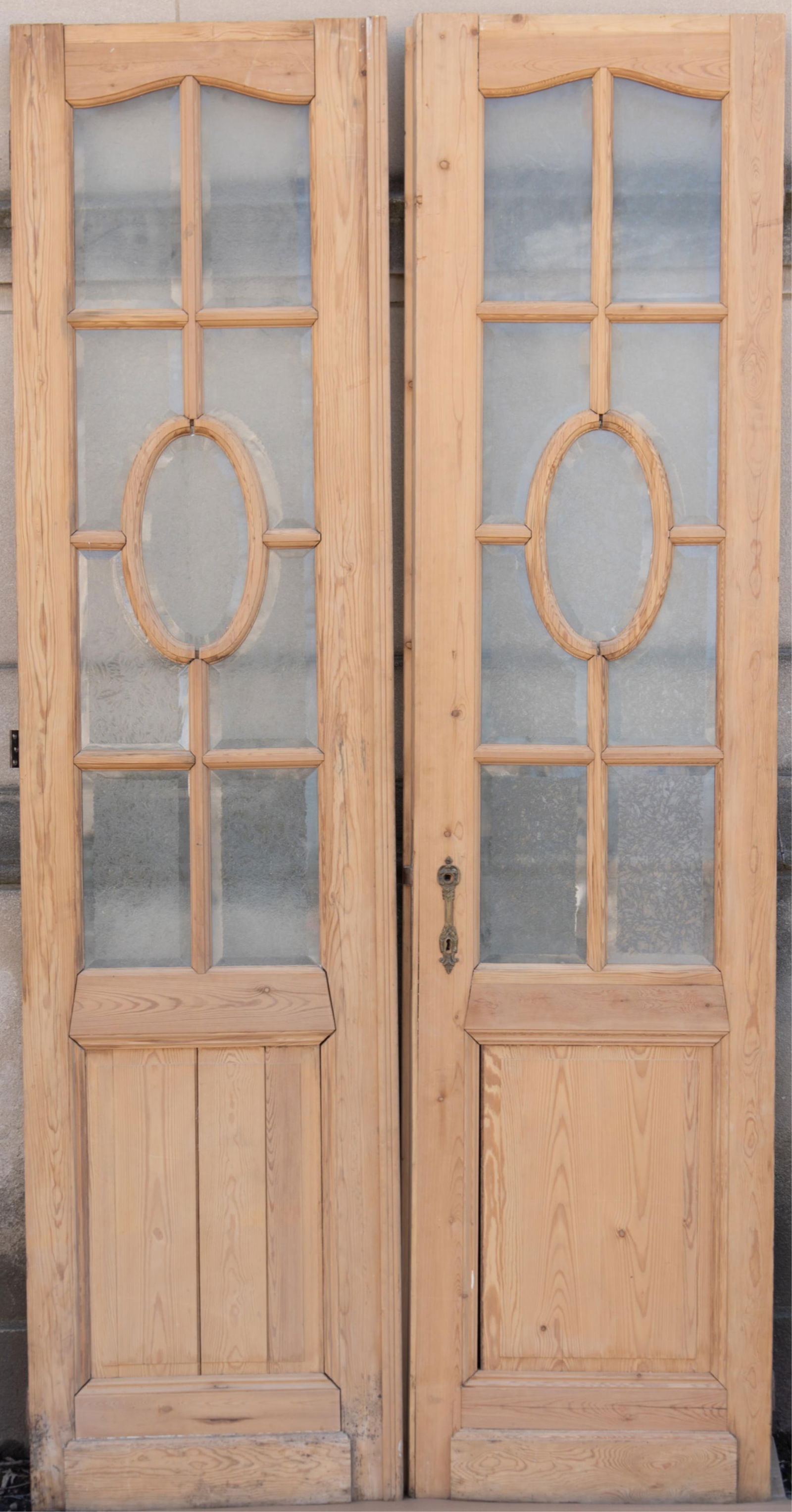 A Pair of Antique Refinished Italian Pine Door Panels: A Pair of Antique Refinished Italian Pine Door Panels Each door consists of frosted glass panels with an oval glass panel in the center. Simple pine panels adorn each door. 103 x 26 inches (each
