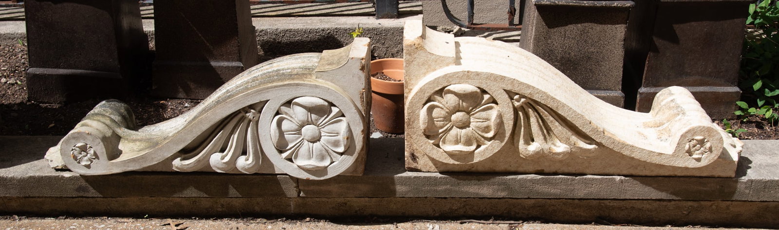 Two Similar Massive Glazed Terracotta Corbels: Two Similar Massive Glazed Terracotta CorbelsEach piece features a prominent rosette or floral carving at the center of a scrolled design.15 x 37 x 10 inches (each)