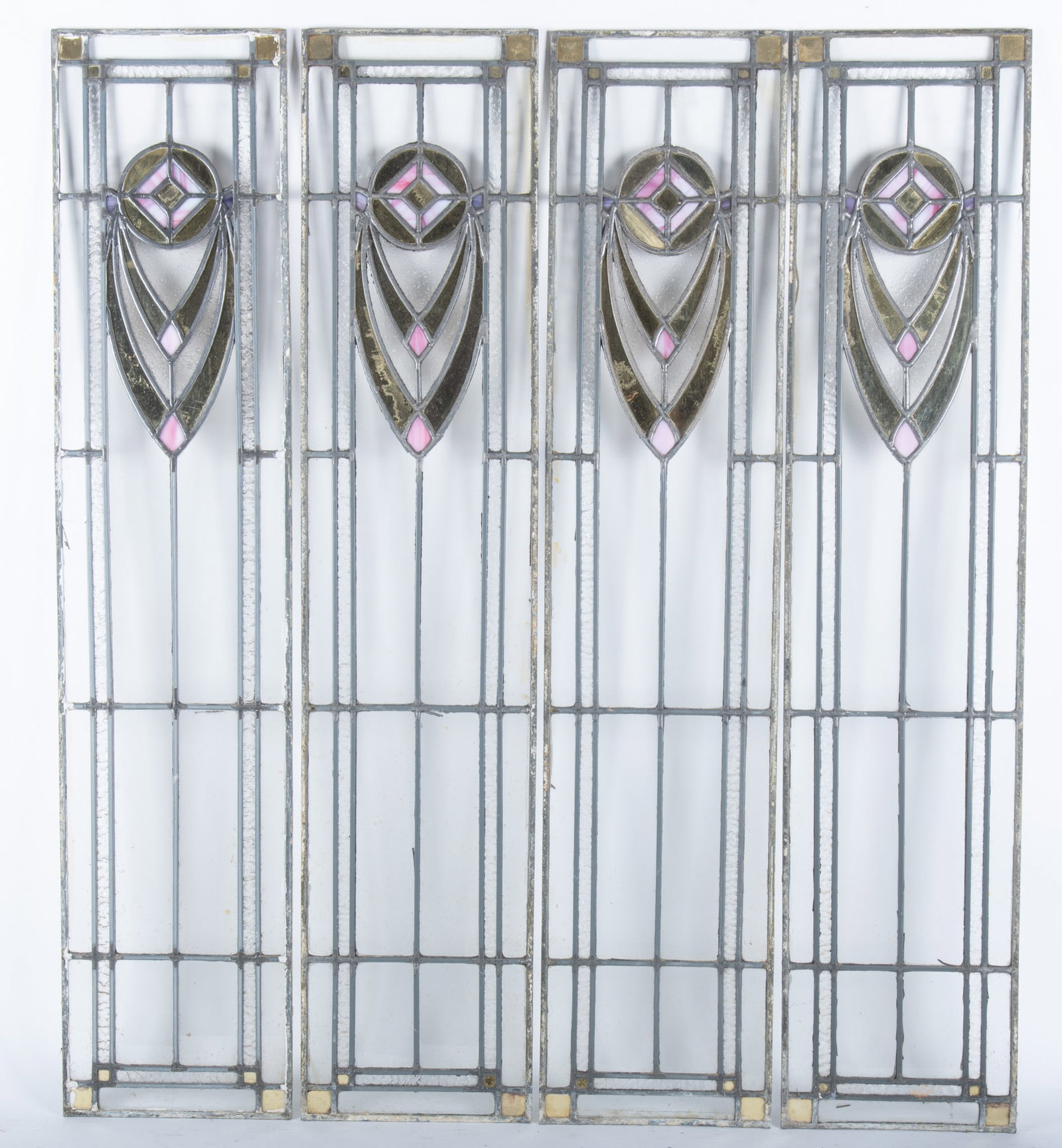 Four Antique Stained Glass Window Panes: Four Antique Stained Glass Window PanesBeveled clear glass panes with colored glass accents in the center depicting art nouveau geometric designs inspired by the work of Macintosh.42 x 9 inches each