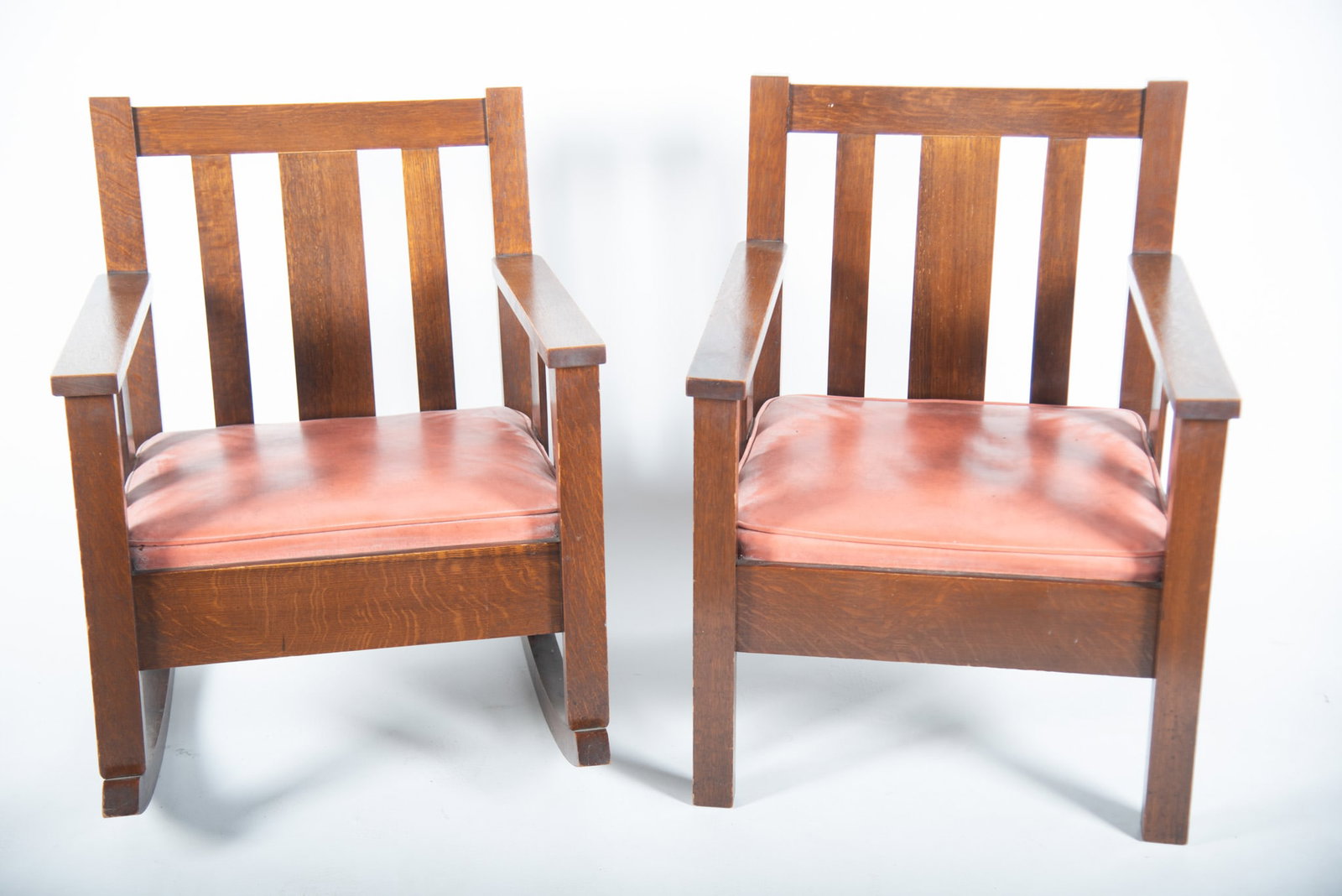 Two Pieces: Oak Arts And Crafts Rocker And Matching Side Chair: Two Pieces: Oak Arts And Crafts Rocker And Matching Side Chair Each with a thick center vertical slat and two narrow slats above orange upholstered seats. Arm chair 34 x 25 x 25, Rocker 33 x 26 x 31