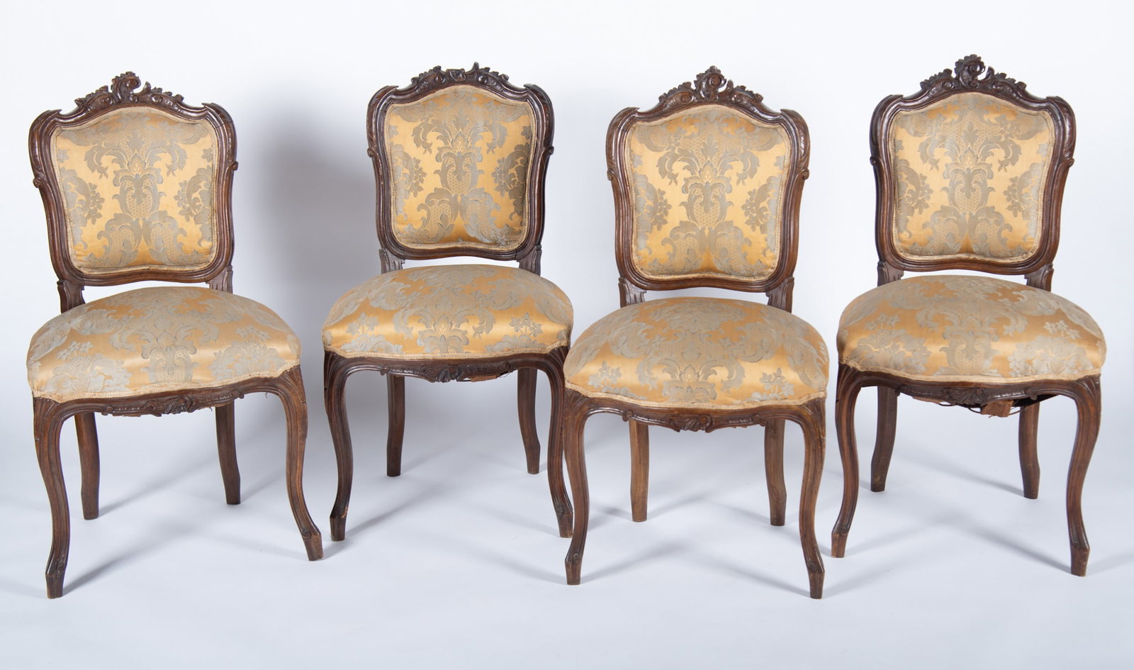 Louis XV Side Chairs: Louis XV Side Chairs Four Louis XV arm chairs having carved crests and serpentine seat rail with original upholstery, late 19th century 35 x 19 x 19 inches