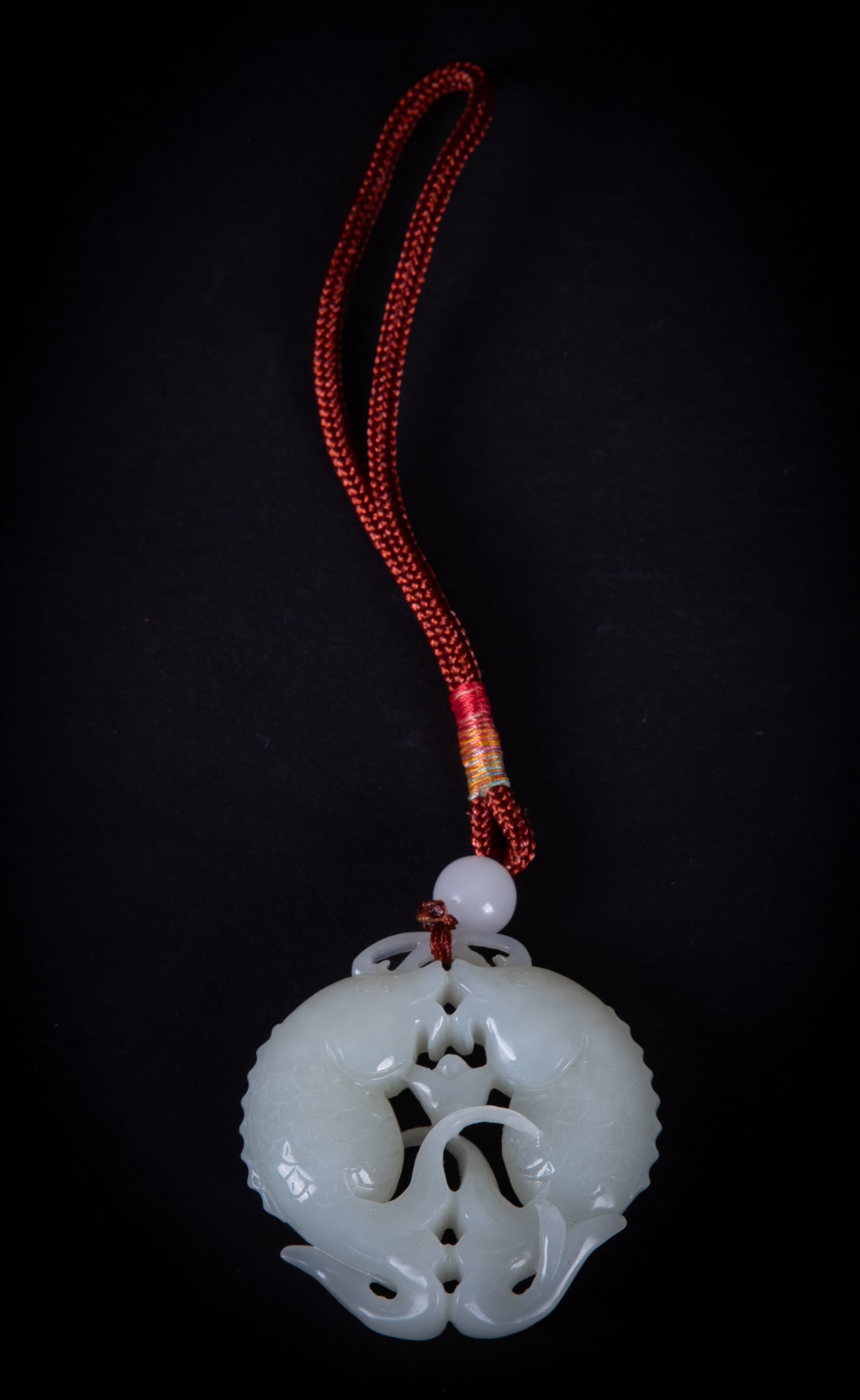 White Jade Carved Ornament: White Jade Carved Ornament Double fish carving in white jade attached to a bead and red rope. ornament measures 2 x 2 inches