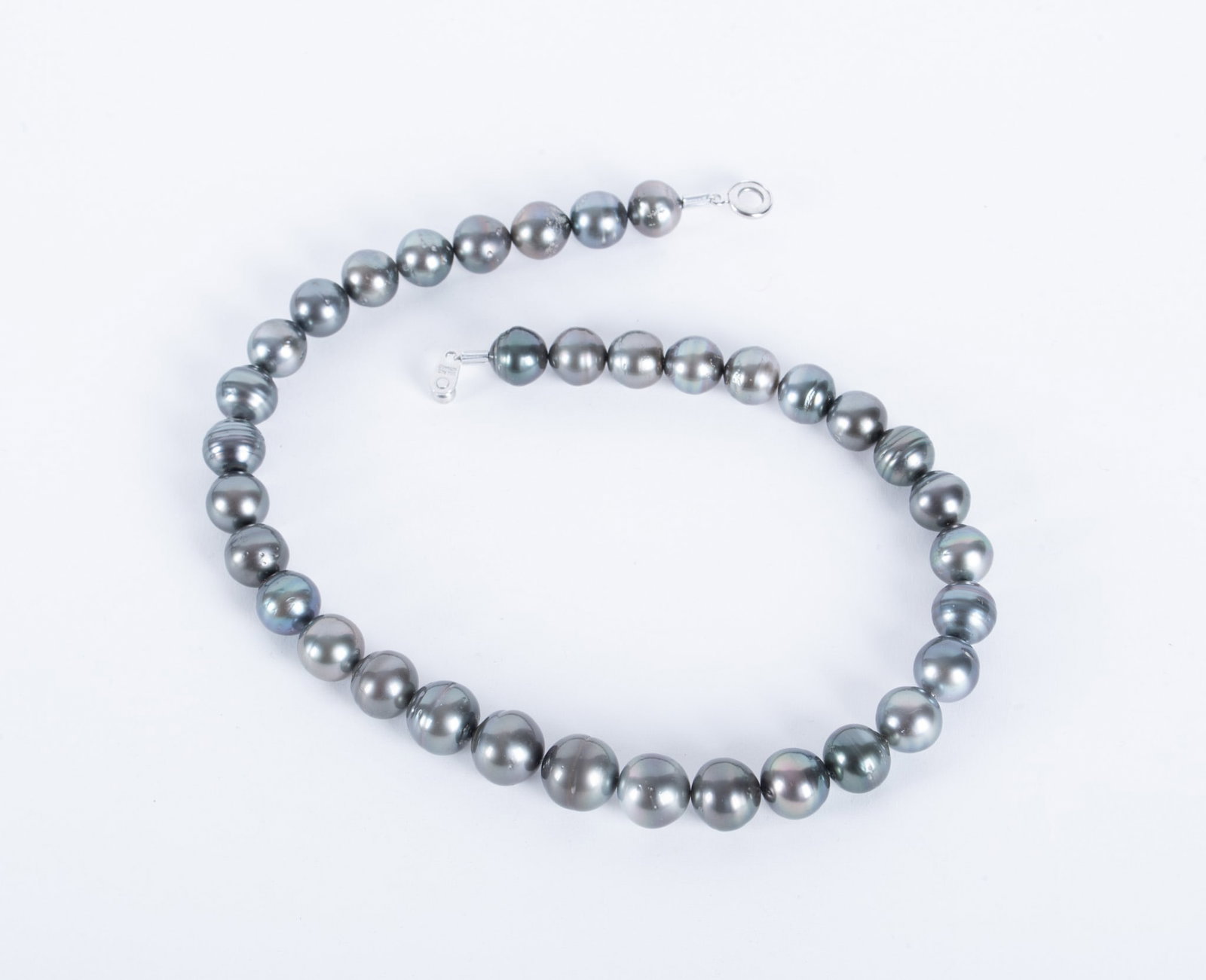 Tahitian Black Pearls: Tahitian Black Pearls These pearls are graduated with the largest being 13mm and the smallest 11mm. They are strung on thread with a commercial closure as they are sometimes purchased that way. You