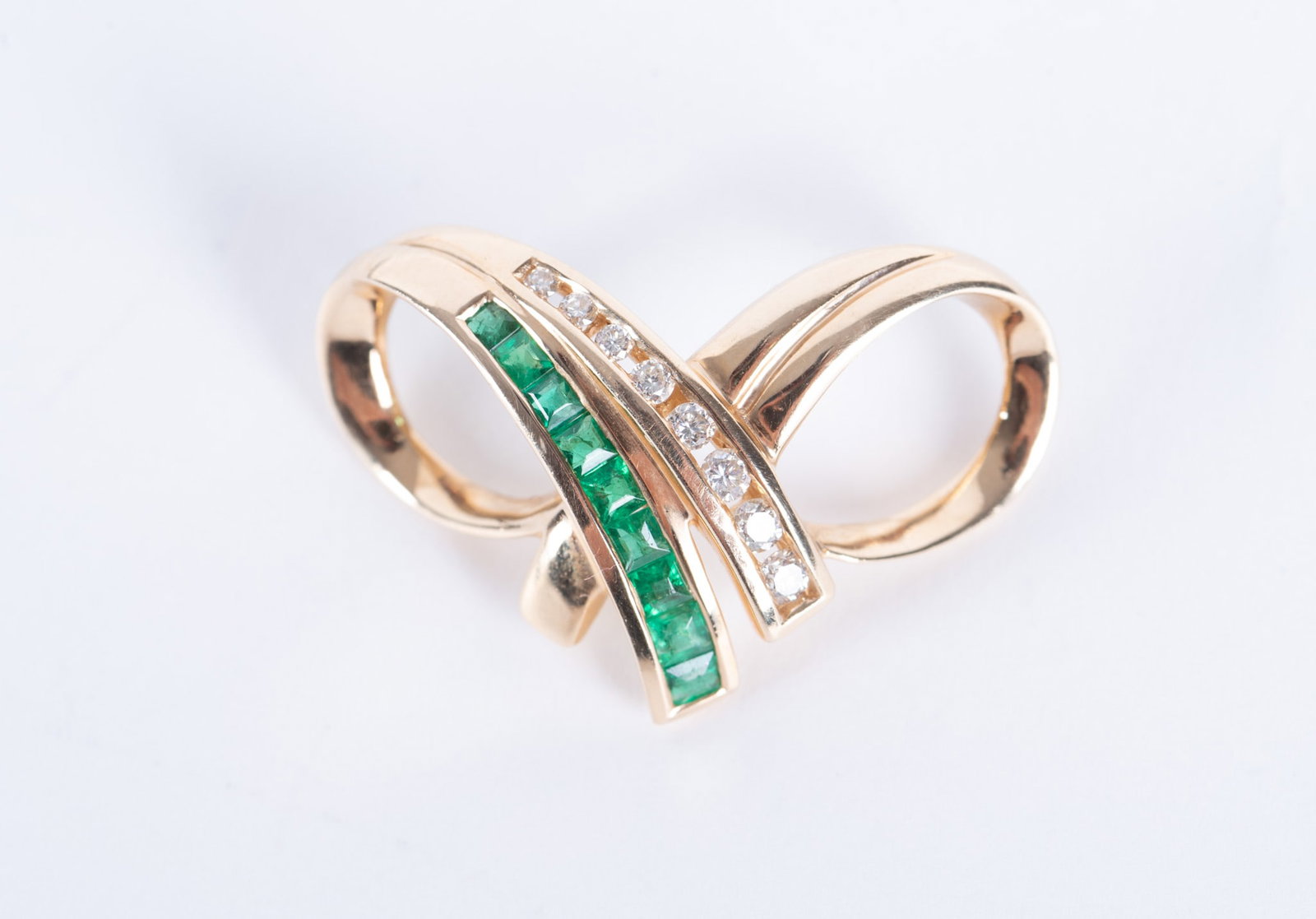 14K Yellow Gold, Emerald and Diamond Pendant: 14K Yellow Gold, Emerald and Diamond PendantTwist bow shape; 1 14" x 3/4"; total weight 5 grams
