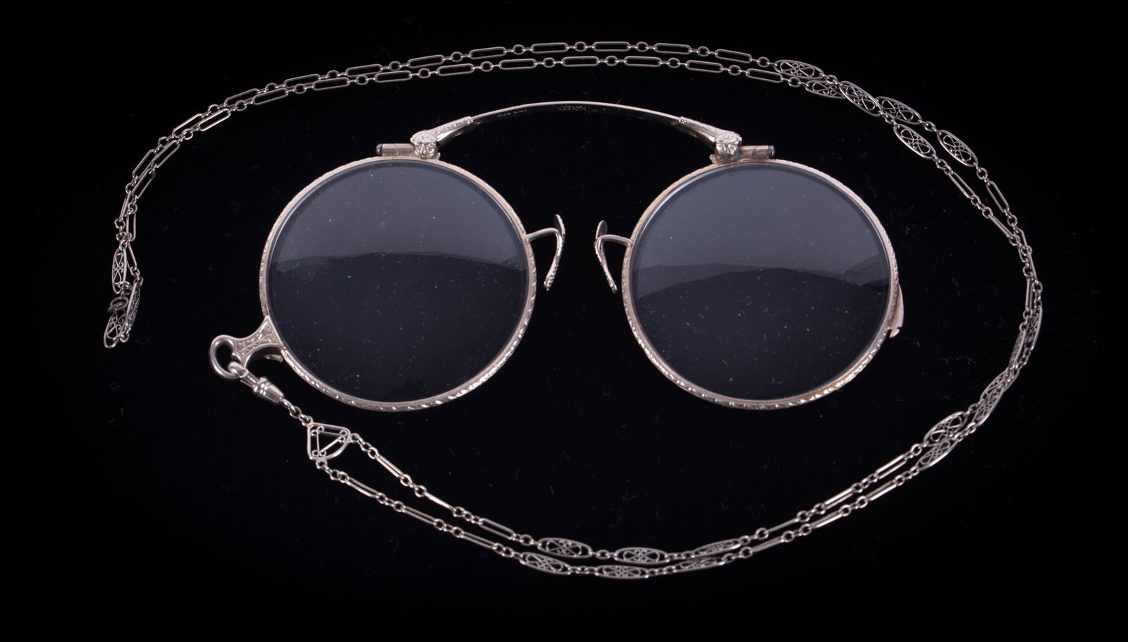 Antique Lorgnette Folding Eyeglasses: Antique Lorgnette Folding EyeglassesThese glasses come with a lovely decorative chain that measures 28 inches. The glasses fold and lock into place. The nose bridge is marked "The Hutton Oxford" 14K S
