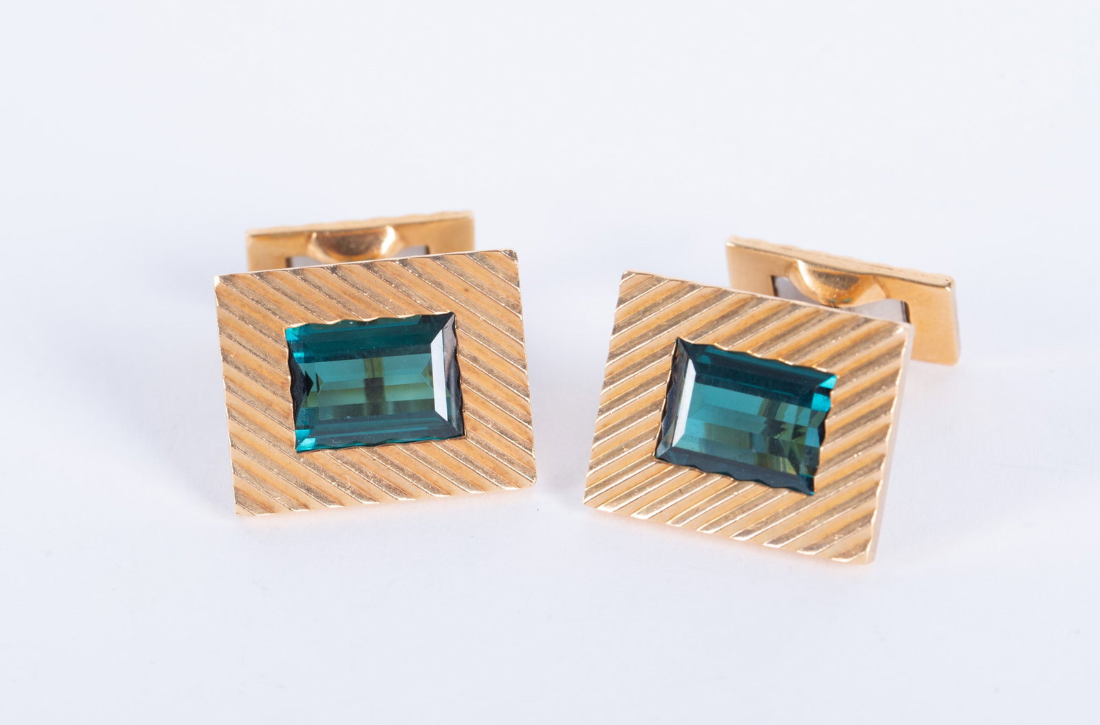 18K Yellow Gold Cufflinks set with Tourmaline: 18K Yellow Gold Cufflinks set with TourmalineThe stones in these cufflinks are a wonderfull blue-green color. They measure 10.30mm x 7mm. They test 18K. Weight including stones is 23g.