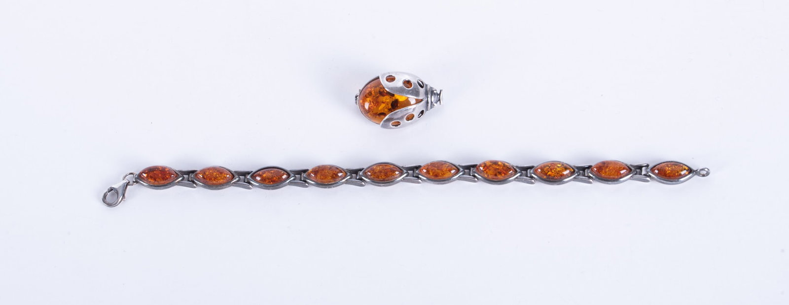Sterling with Amber Bracelet and Brooch: Sterling with Amber Bracelet and BroochThe bracelet is 7 inches long and the small beetle brooch is an inch long. Weight including stones is 19g.