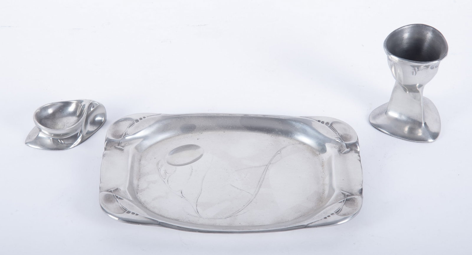Kayserzinn Art Nouveau Pewter Table Articles: Kayserzinn Art Nouveau Pewter Table ArticlesAll three marked on the underside. Features a tray, salt cellar, and a possible egg cup holder.8 1/4 x 5 5/8 inches (tray)