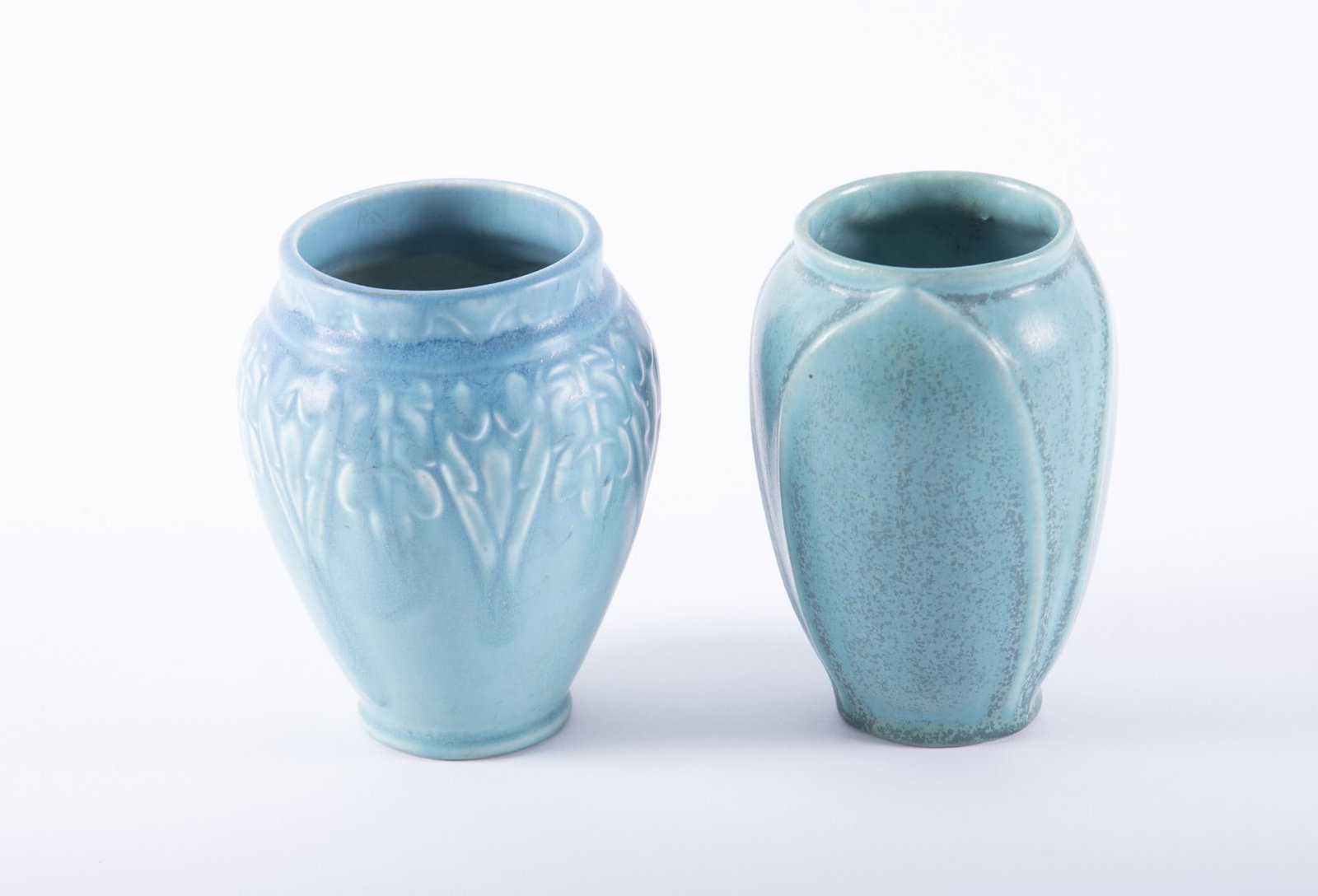 Two Rookwood Blue Production Glaze Vases: Two Rookwood Blue Production Glaze VasesCincinnati, mold 2282 lotus-form vase dated 1935; and a mold 2207 vase having a Art Deco botanical motif dated 1927.Both 5 1/4 inches tall