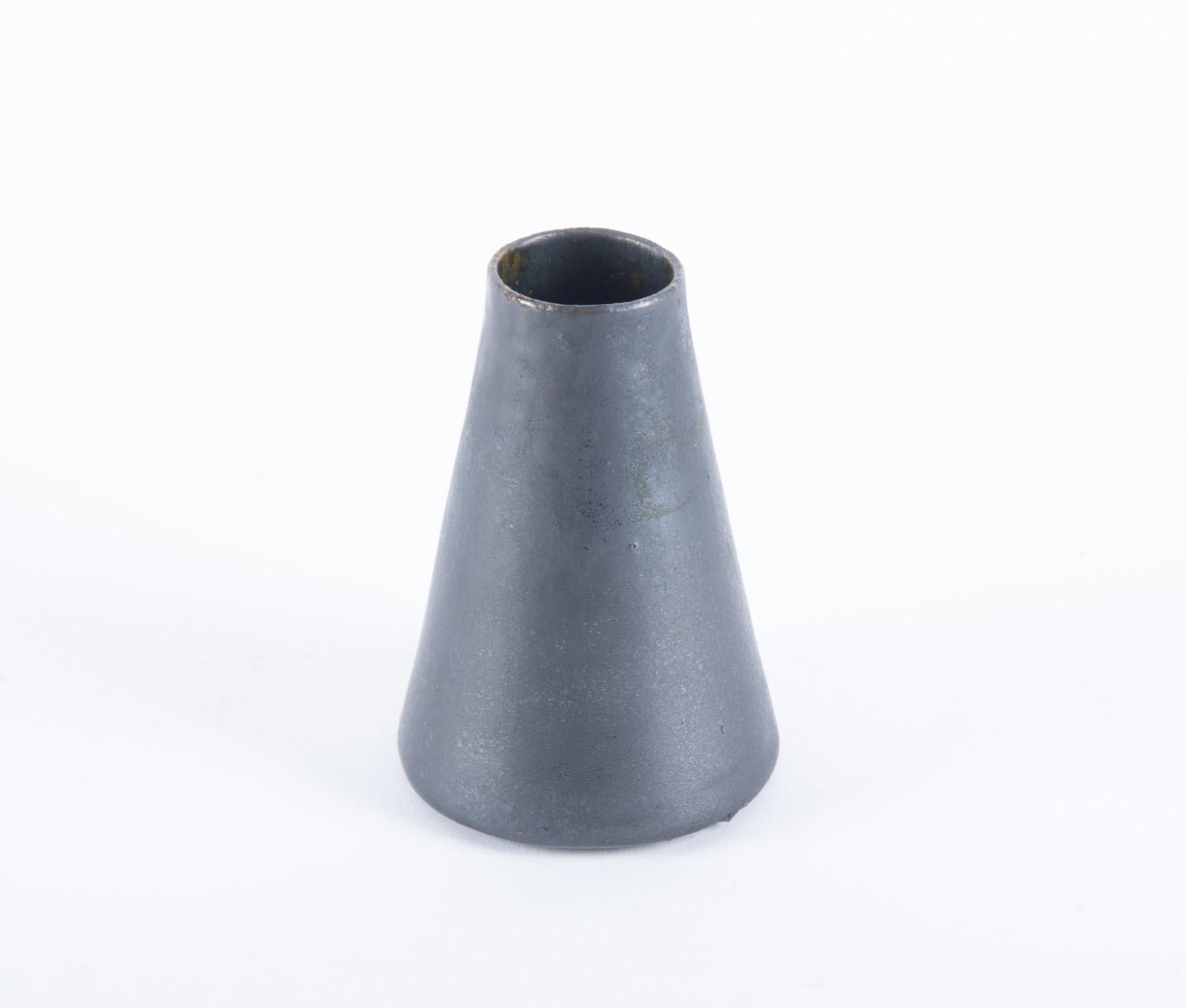 An American Art Pottery Vase, George Ohr: An American Art Pottery Vase, George OhrBiloxi, circa 1900, a nicely potted thin-wall conical shaped vase having a black gun metal glaze. Signed to base: OHR2 1/2 x 3 1/2 inches