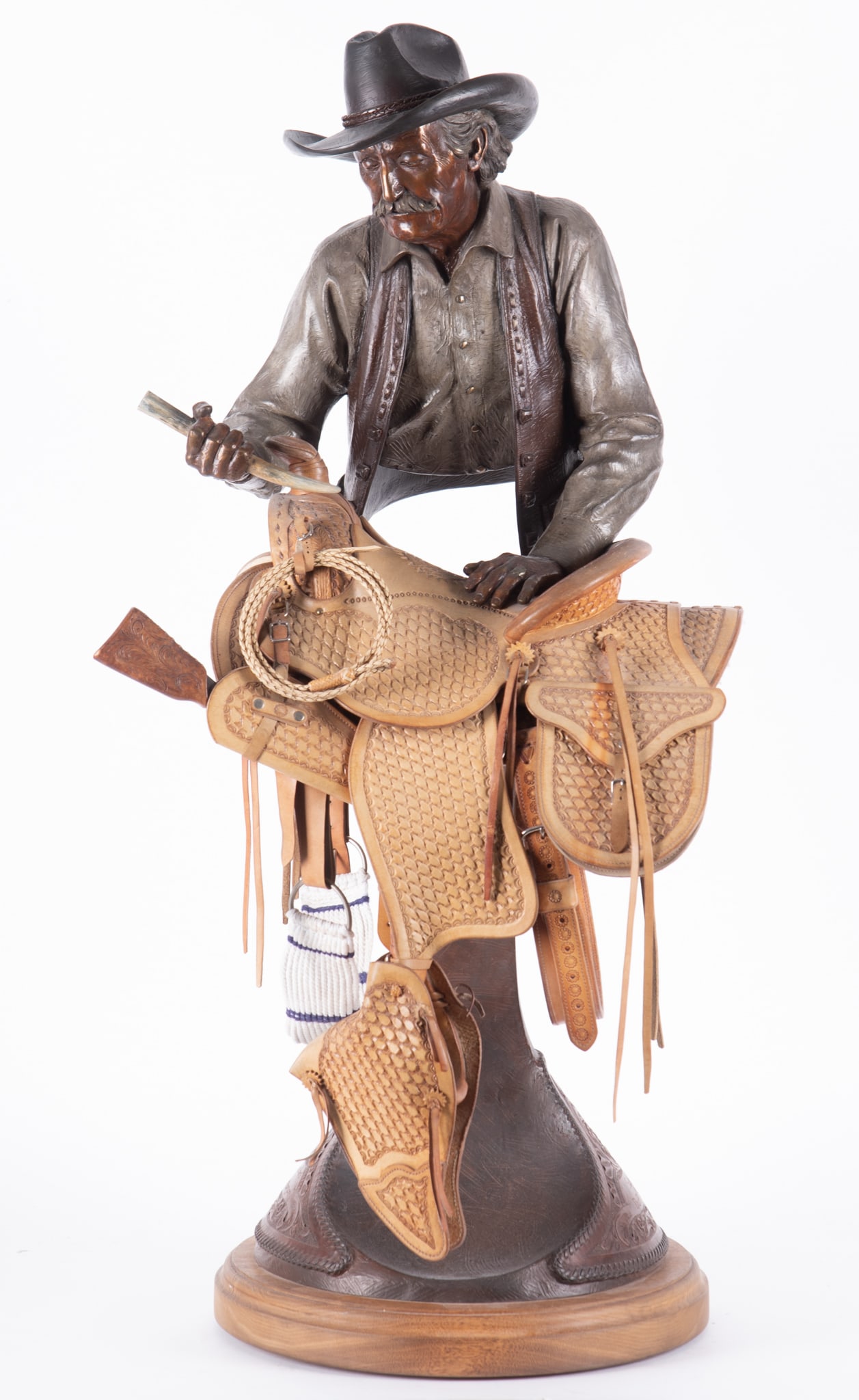 Clyde Morgan, Arizona (b. 1942), Saddle Maker, 1993, bronze with leather saddle: Clyde MorganArizona, (b. 1942)Saddle Maker, 1993bronze with leather saddlesigned and datedHeight: 36 inches