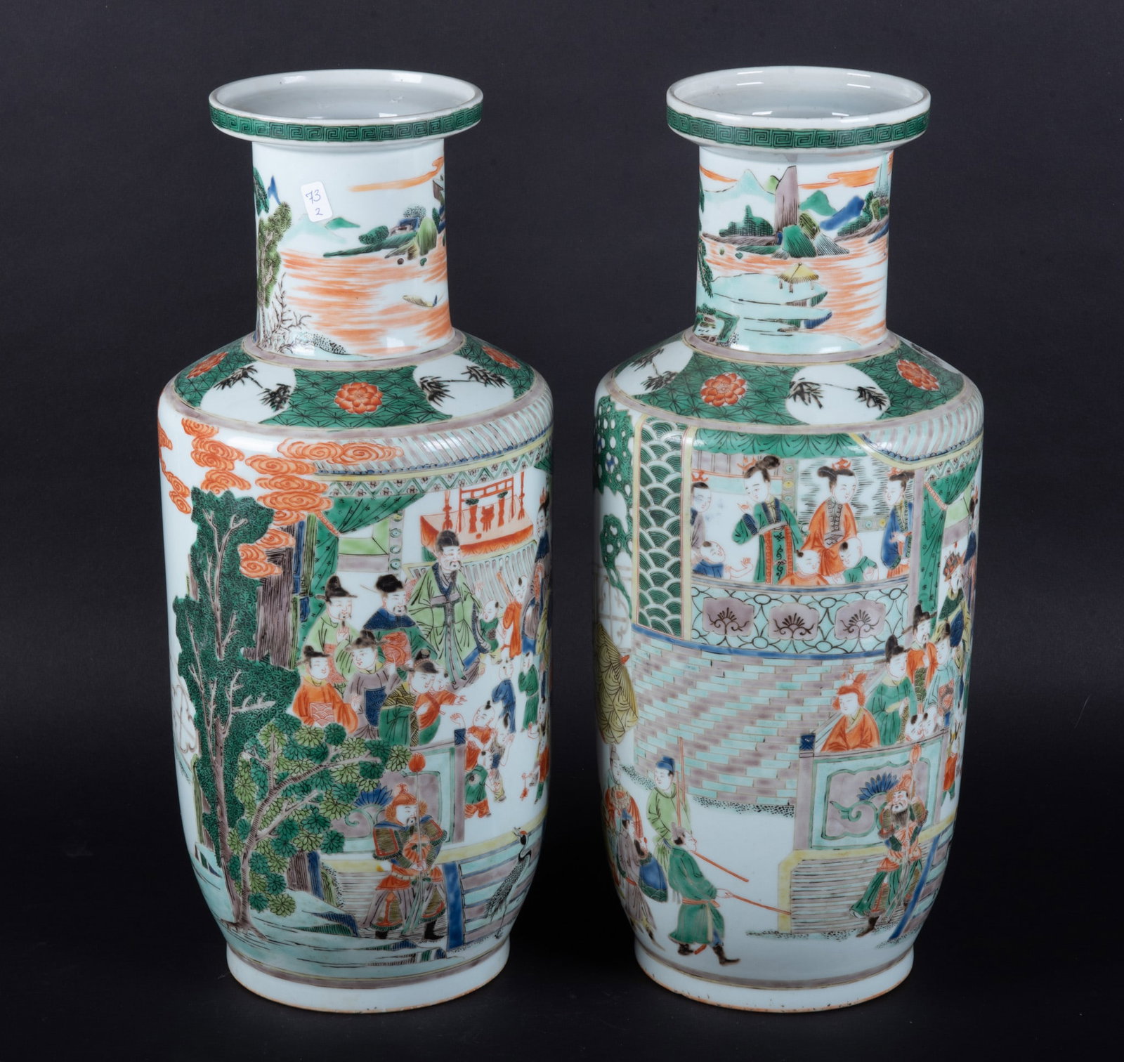 A Pair of Chinese Famille Verte Rouleau Vases: A Pair of Chinese Famille Verte Rouleau Vases China, the pair decorated with continuous scenes of multiple figures in garden and court settings. Of Kangxi style bearing 6 character mark. 8 inches