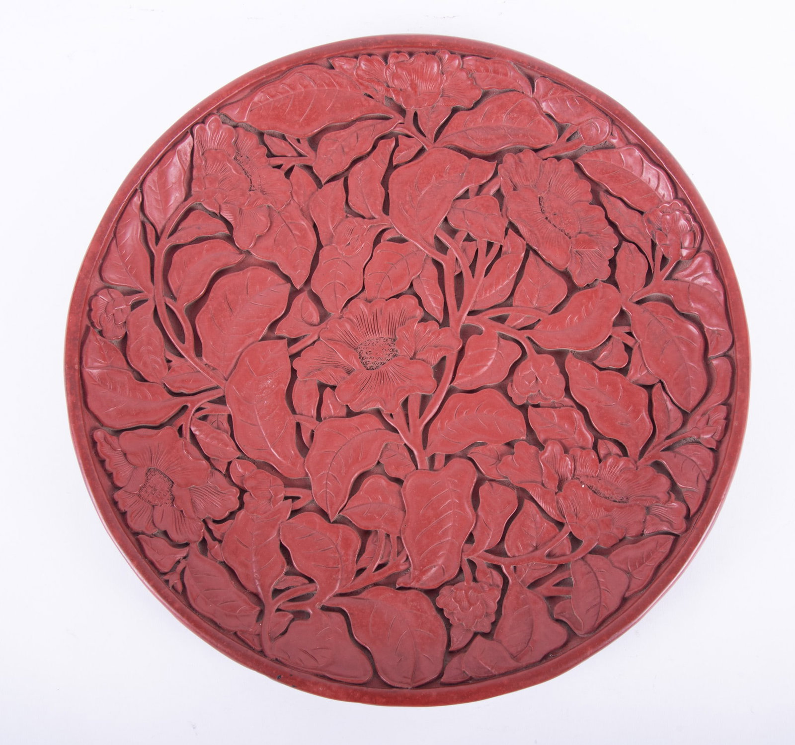 A Finely Detailed Chinese Cinnabar Lacquer Charger: A Finely Detailed Chinese Cinnabar Lacquer Charger China, the front featuring a deep relief-carved floral design, the underside with a large poetic script. diameter: 13 3/4 inches