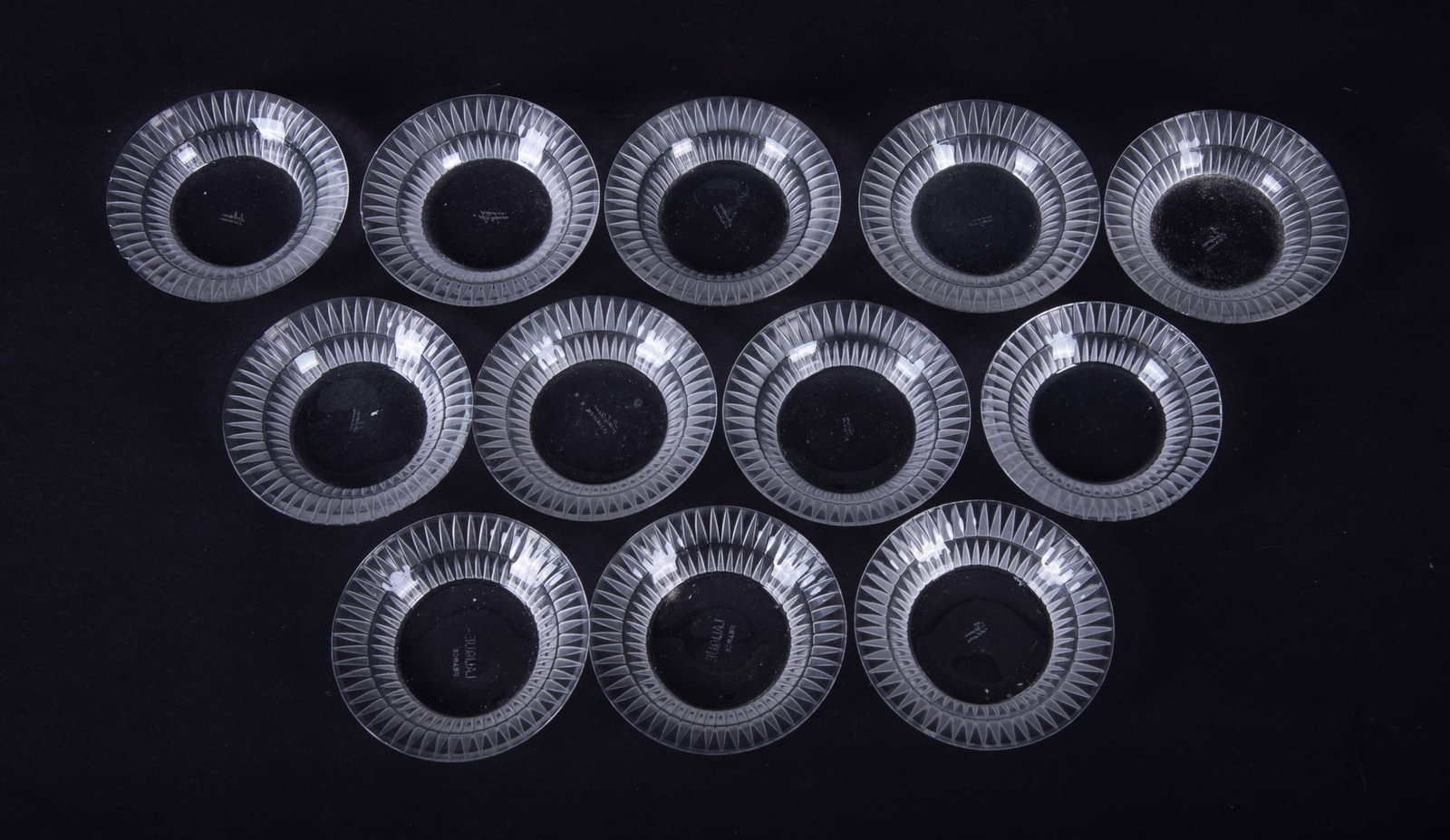 A Set of Twelve Lalique Bourgueil Butter Pat Trinket Dishes: A Set of Twelve Lalique Bourgueil Butter Pat Trinket Dishes France, late 20th century, 12 clear and frosted glass dishes with radial ribbing design, signed Lalique France. Can be used as butter
