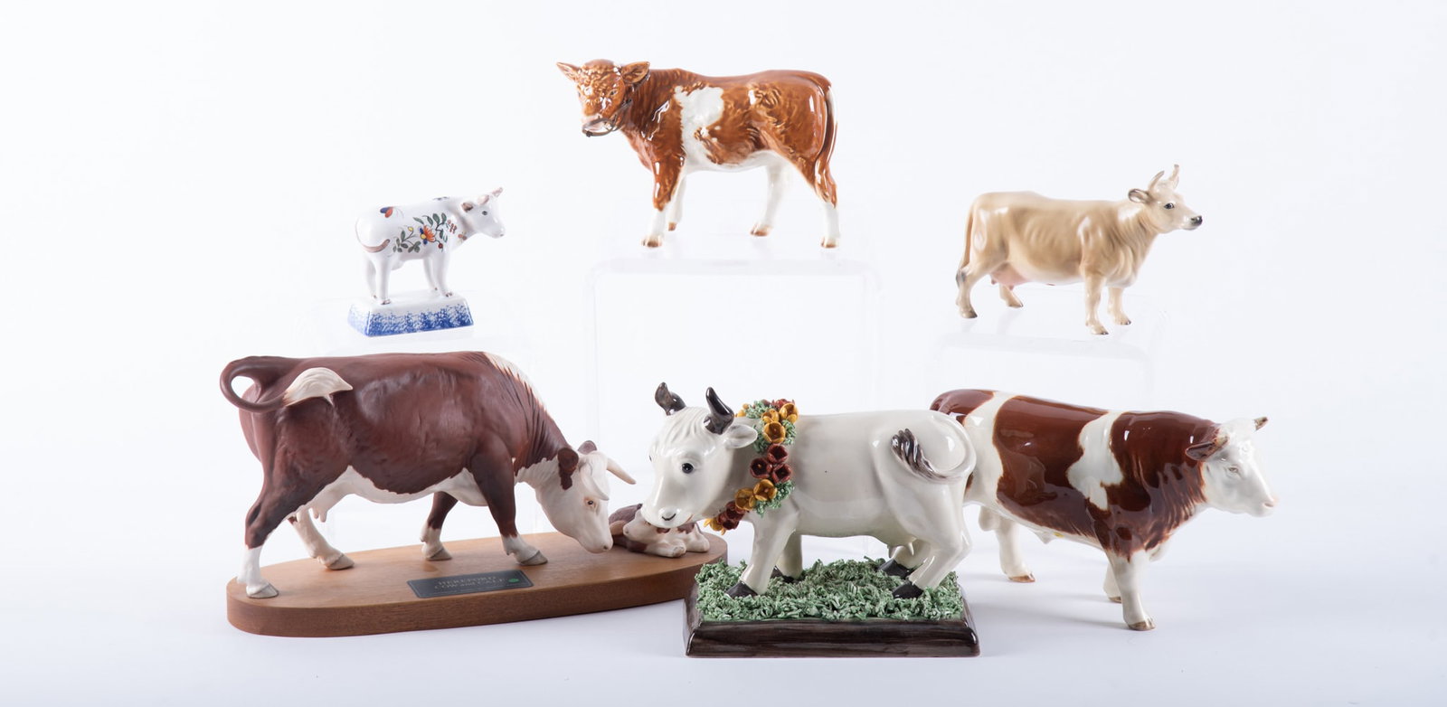 A Collection of Porcelain and Pottery Cow Figurines (1 of 4)
