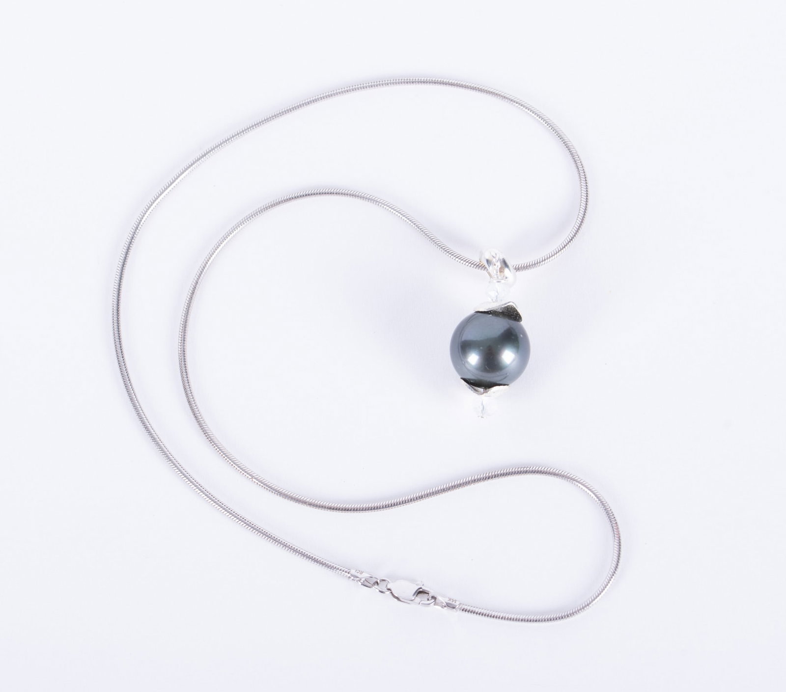 Tahitian Black Pearl Necklace and Earrings: These spectacular Tahitian black pearls have charcoal undertones and measure 12.90mm. They are enhanced with silver adornments. The ear wires and the 16 inch chain are sterling.