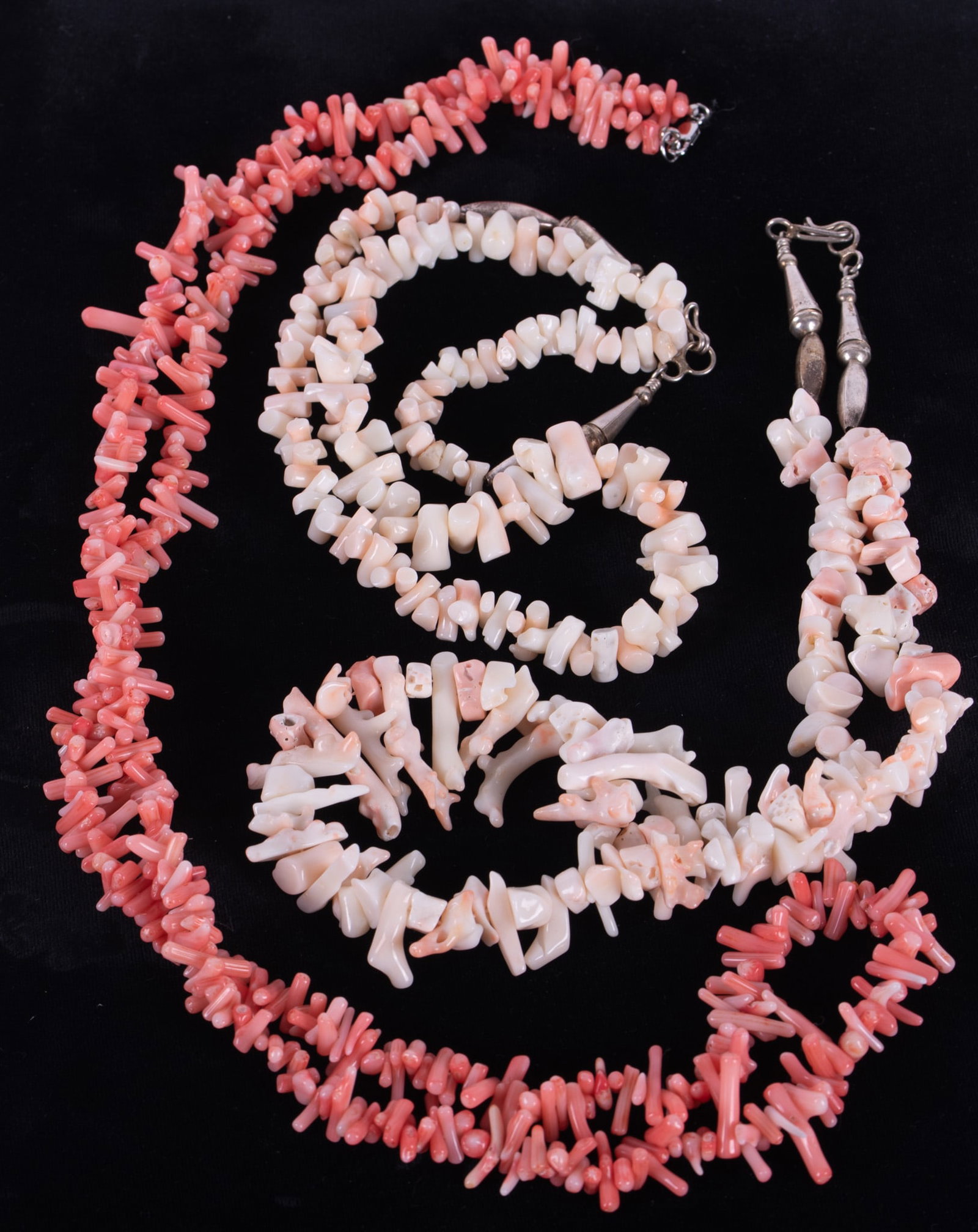 Three Vintage Angel Hair Branch Coral Necklaces: Two of the necklaces feature pale pink and white coral pieces. They have sterling closures and both measure 22 inches long. The third strand is a pale pink color and measures 35 inches long.