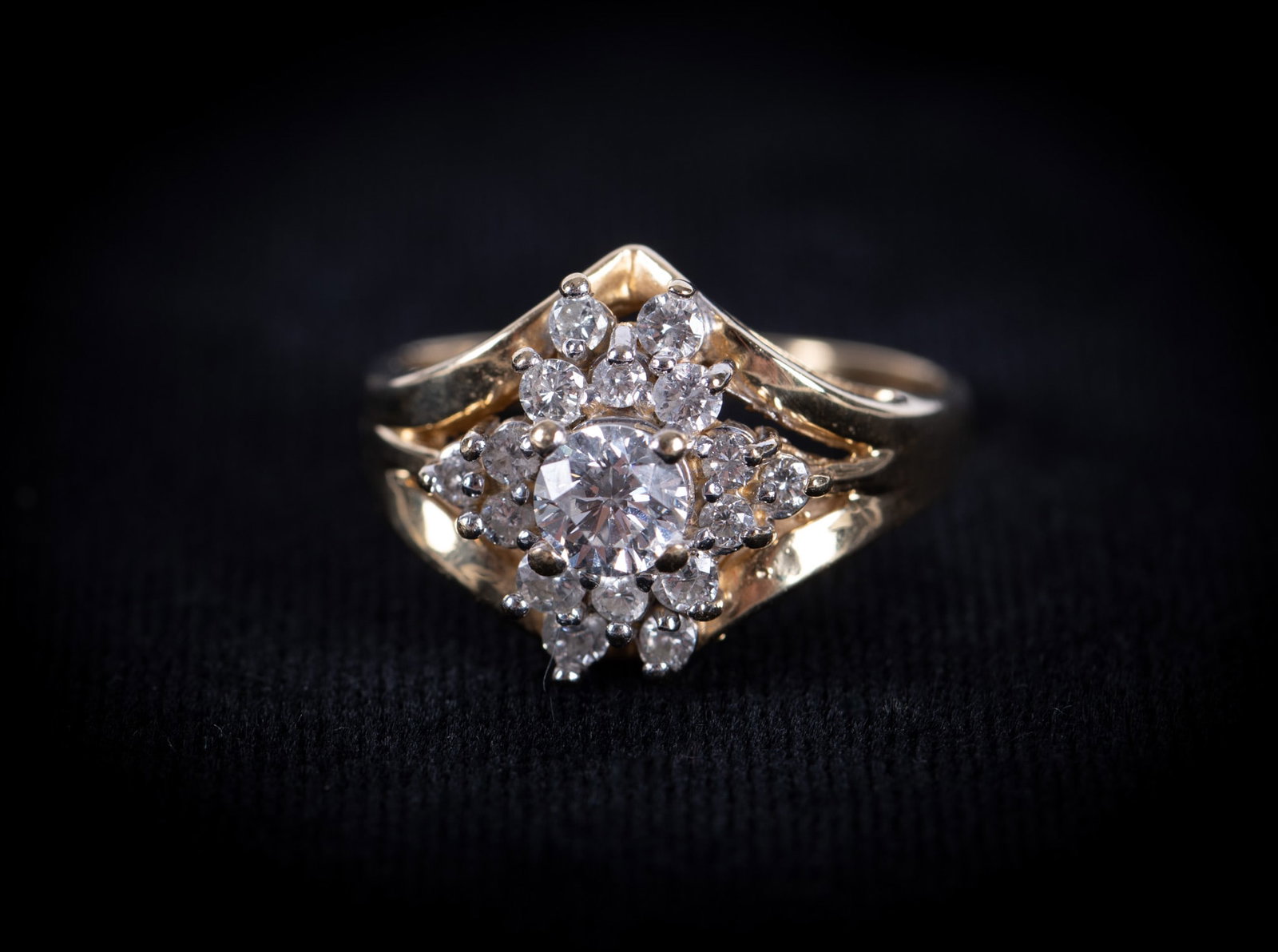 Vintage 14K Yellow Gold & Diamond Ring: The center brilliant cut diamond is approximately .33 carat with the remaining diamonds weighing approximately .60ctw. Ring size is 7 3/4 and the weight including stones is 5.2g.