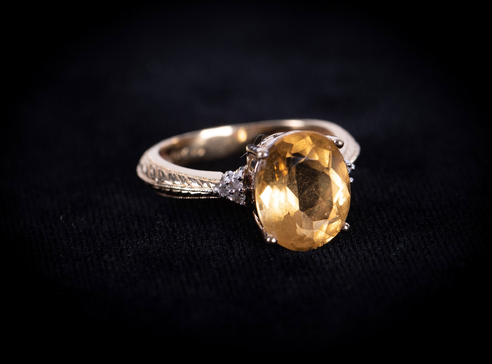 14K Yellow Gold Ring set with Citrine & Diamonds: The citrine measures 12mm x 10mm and is embraced by 3 small diamonds on each side. Trailing down both sides of the band is a nicely engraved wheat pattern. Ring size is an 8. Weight including stones 5