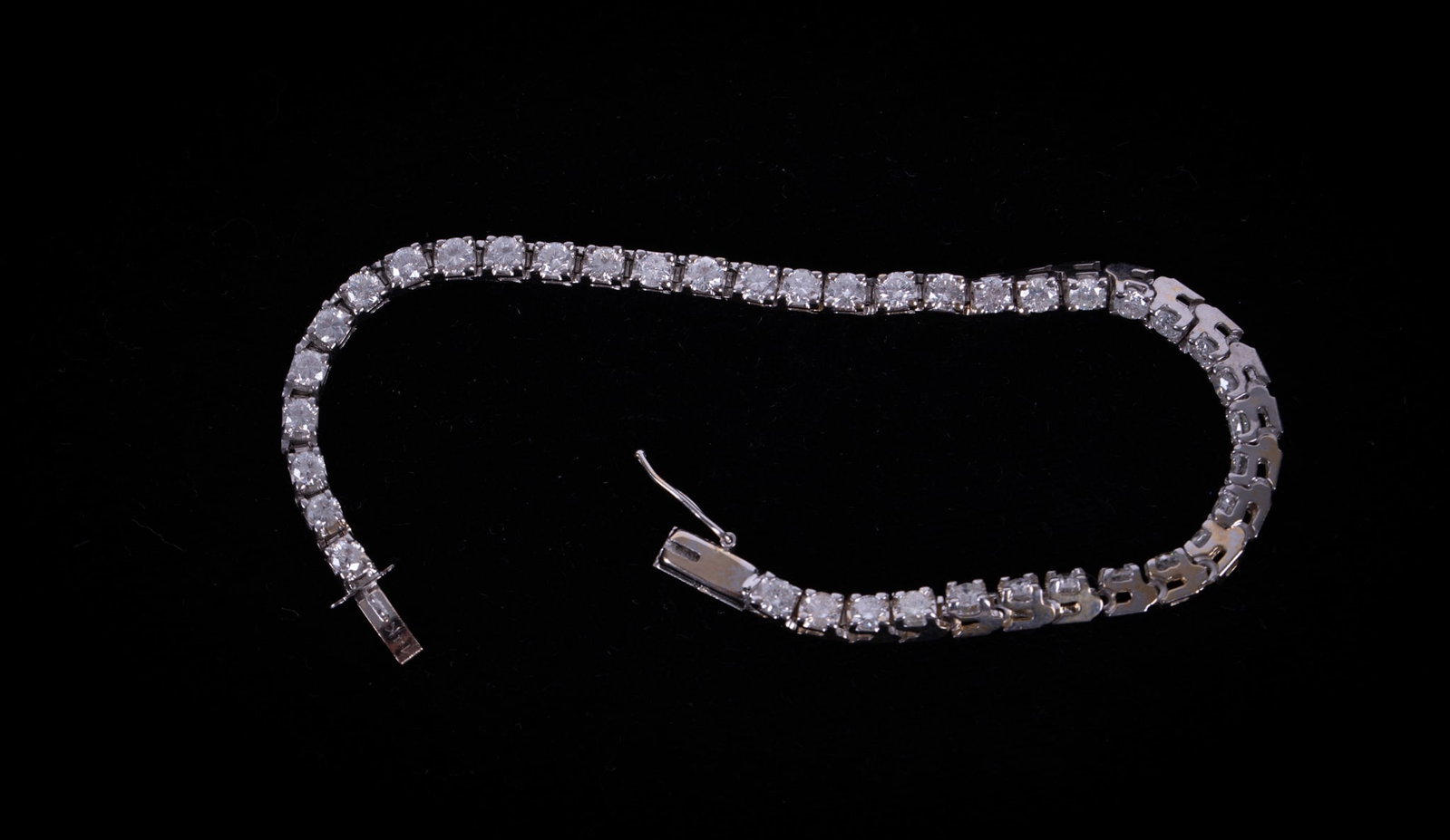 14K White Gold and Diamond Tennis Bracelet: 14K white gold tennis bracelet with 39 round cut diamonds, 3ctw and hidden tongue closure. Marked 14K on clasp. gross weight: 8.5 grams. 6 1/4 inches.