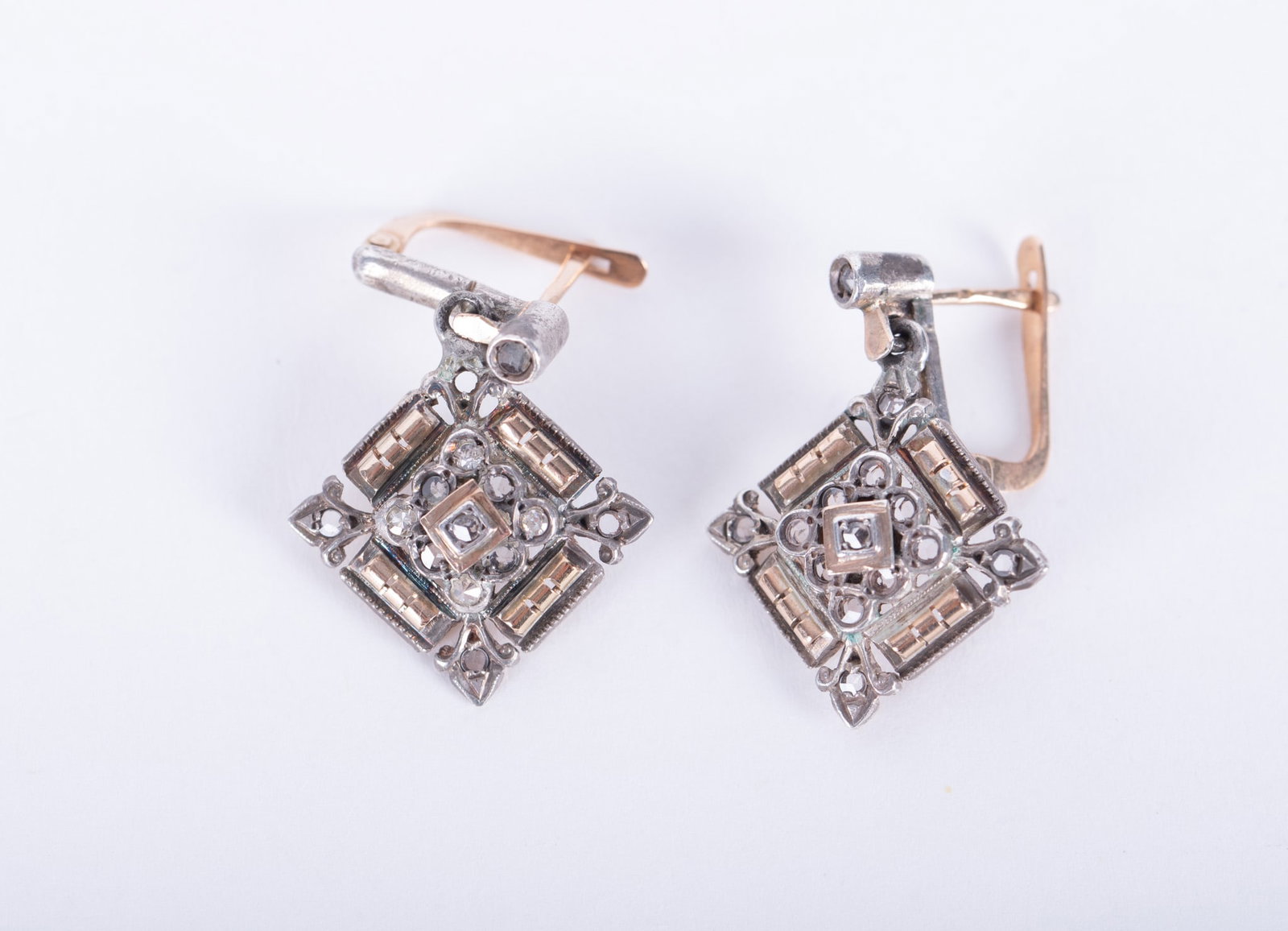 Antique 14K Gold Earrings set with Mine Cut Diamonds: An intricate design on these unique earrings with a mixture of white and yellow gold. One of the tiny diamonds is missing at the top, otherwise good condition. The square piece measures 13.40mm and th