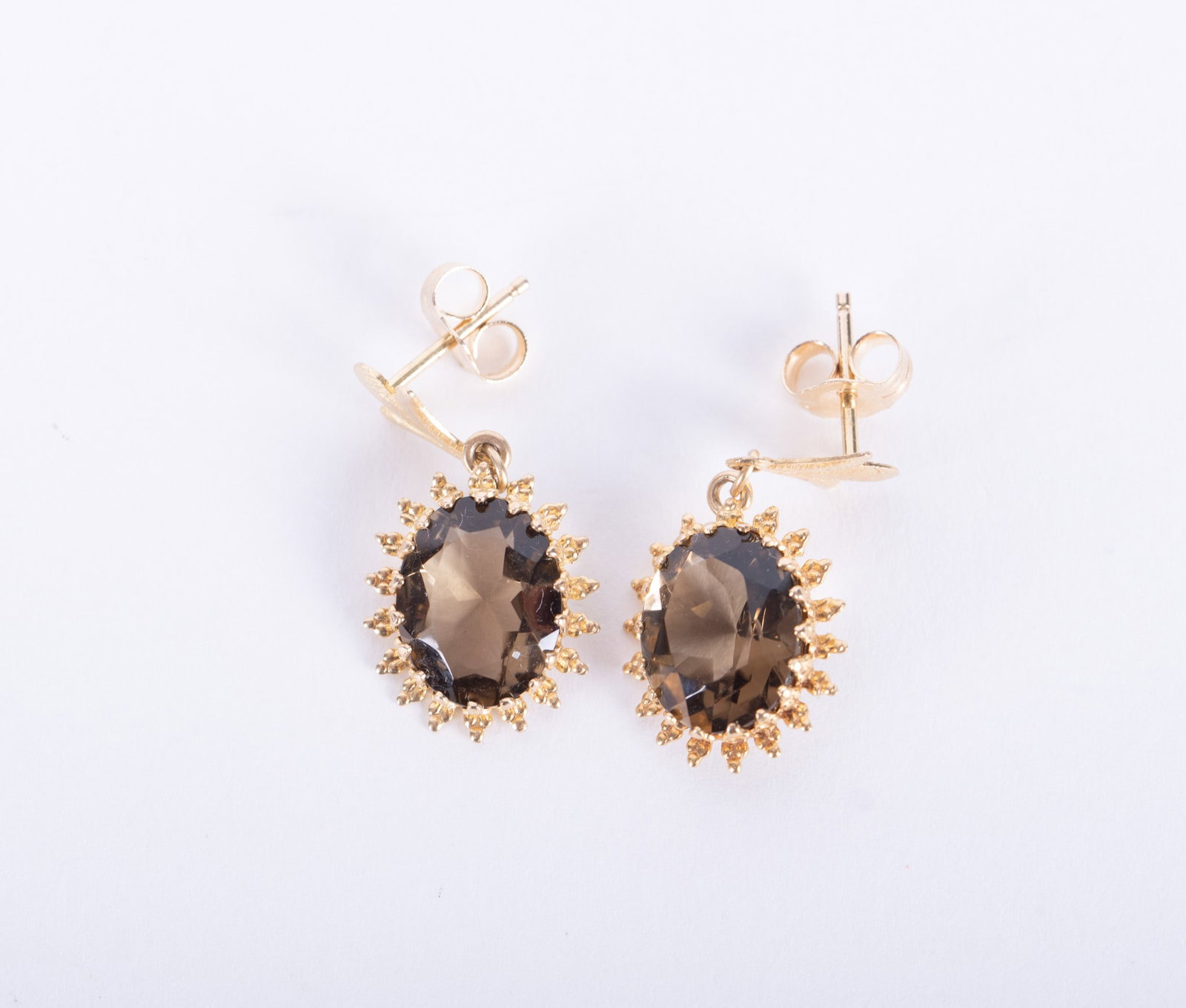 14K Yellow Gold Earrings set with Smoky Quartz Stones: The stones in these earrings measure 9.40mm x 8.30mm. The weight including stones is 2.2g.