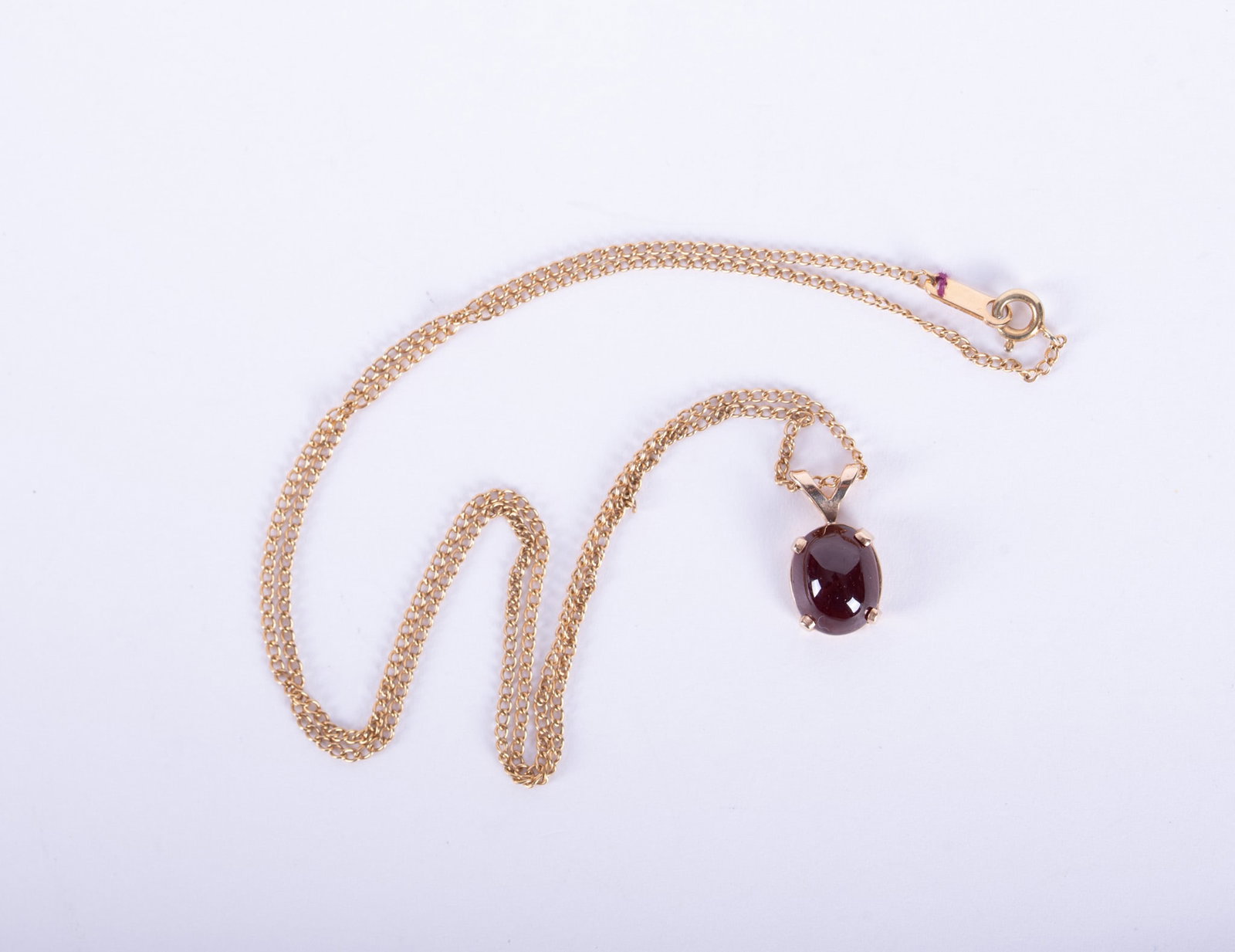 14K Yellow Gold Chain with a Rubelite Tourmaline Pendant: The tourmaline cabochon measures 8.70mm x 7.30mm. The chain is 18 inches long and total weight including stone 3 grams.