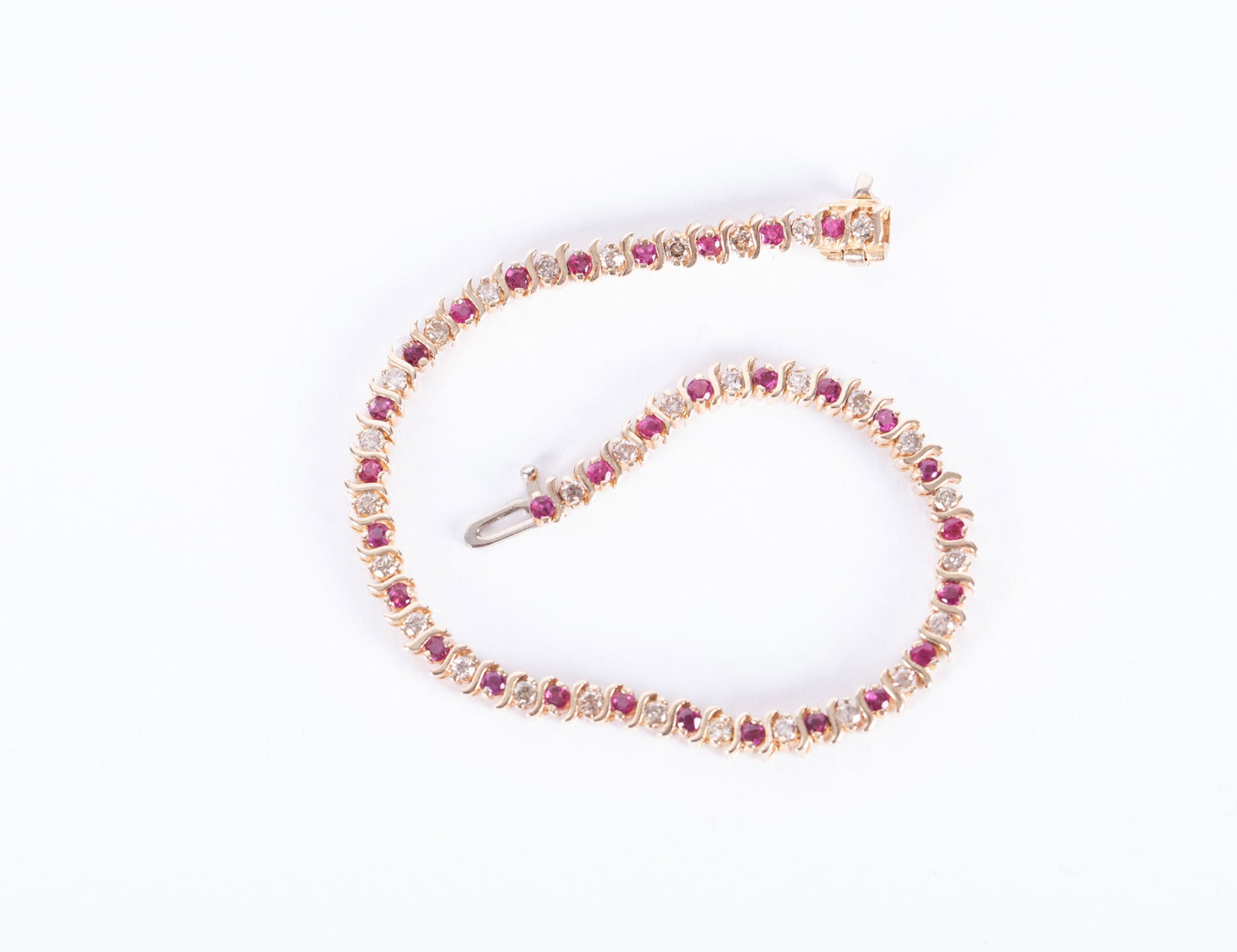 14K Yellow Gold Ruby & Diamond Tennis Bracelet: The length on this bracelet is 7 inches. Diamond weight is approximately .30ctw. Weight including stones is 10.8g.