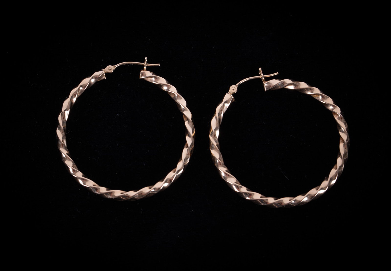 14K Yellow Gold Twisted Hoop Earrings: These classic earrings measure 1 1/2 inches in diameter and weigh 3.2g.