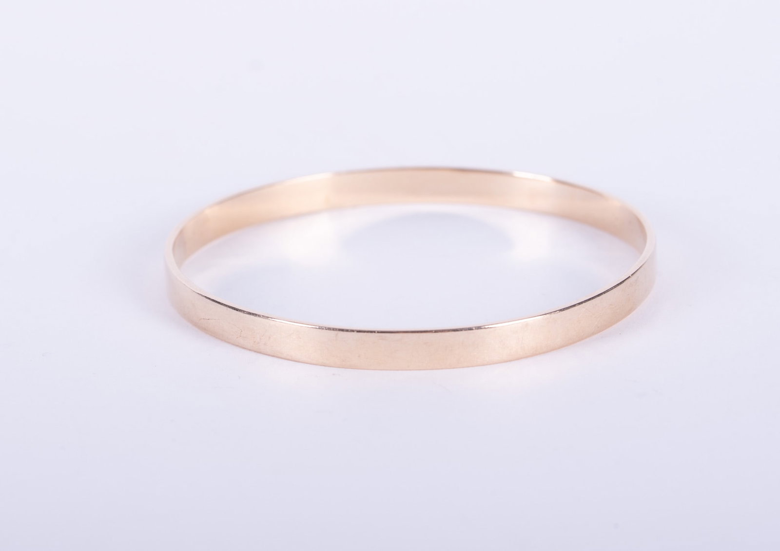 14K Yellow Gold Bangle Bracelet: This bangle tests 14k with a digital tester and by acid testing. The circumference is 7 inches and it weighs 20.9g.