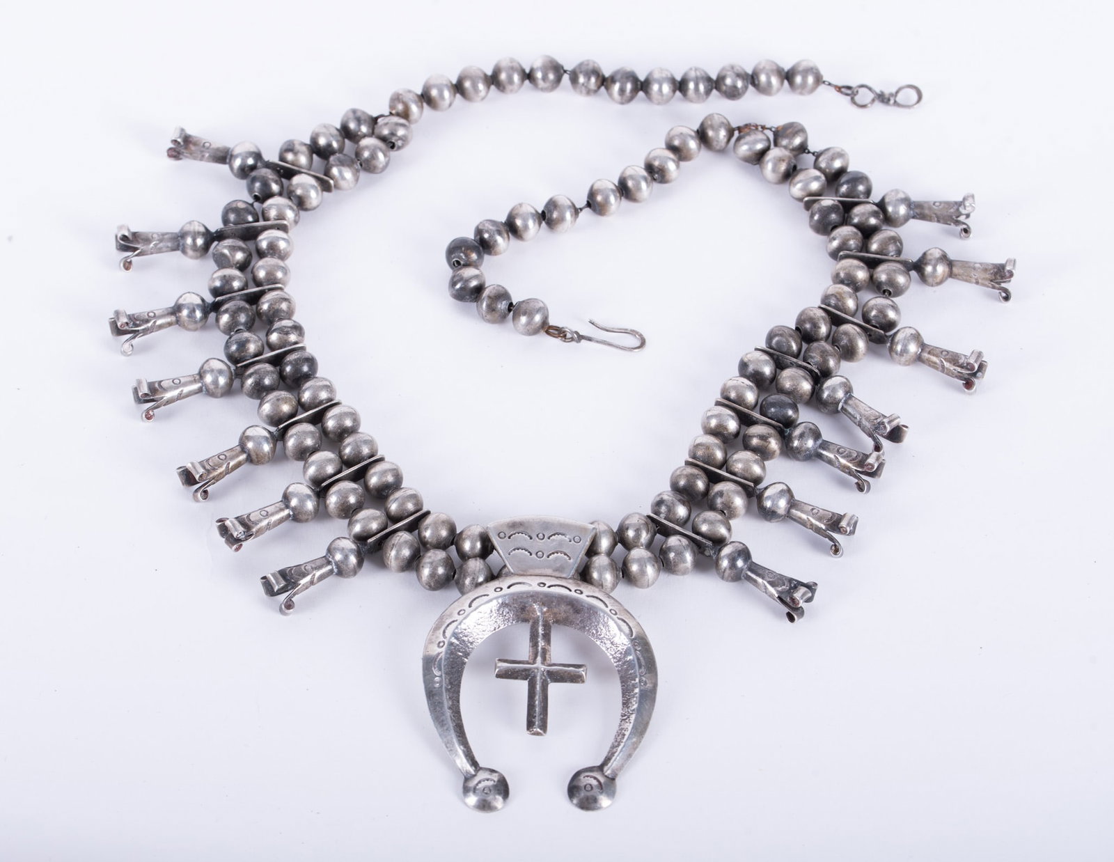 Southwest Navajo HBC Silver Squash Necklace: this silver necklace marked with HBC hallmark, indicating Navajo silversmith/artist, with heavy anchor pendant with cross, length 26 inches; weight 239 grams, 7.68 troy ounces.