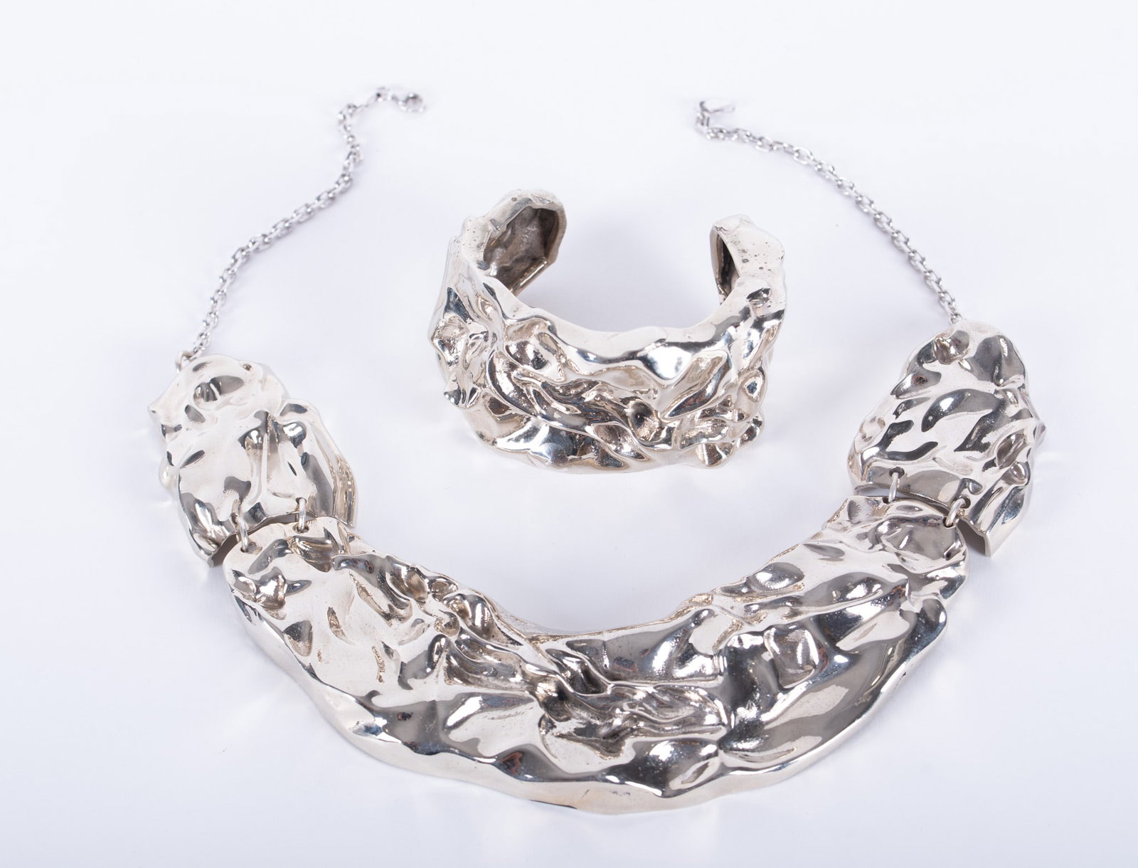Silvered Metal Custom Design Art Modern Choker Necklace and Matching Cuff Bracelet: heavy custom sculptural design silvered metal choker in three sections, width 1 1/2 inches, length 11 inches, chain attached for hooking; together with matching cuff bracelet. Total weight 8.070 troy