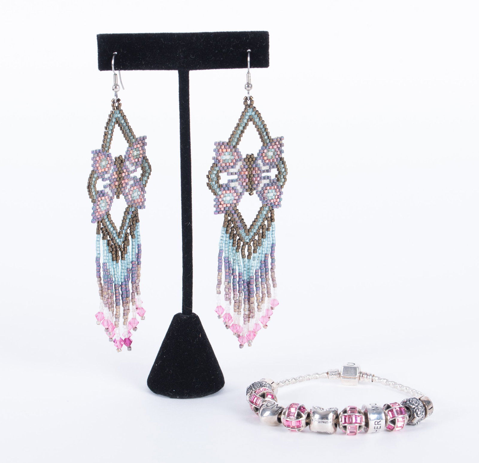 Sterling Chamilia Charm Bracelet paired with Beaded Earrings: "Pretty in Pink", the Chamilia charms are sterling, some with pink Murano glass. Two of them are "Mom" charms. There are a total of 11 charms placed on the sterling Chamilia chain bracelet. Weight
