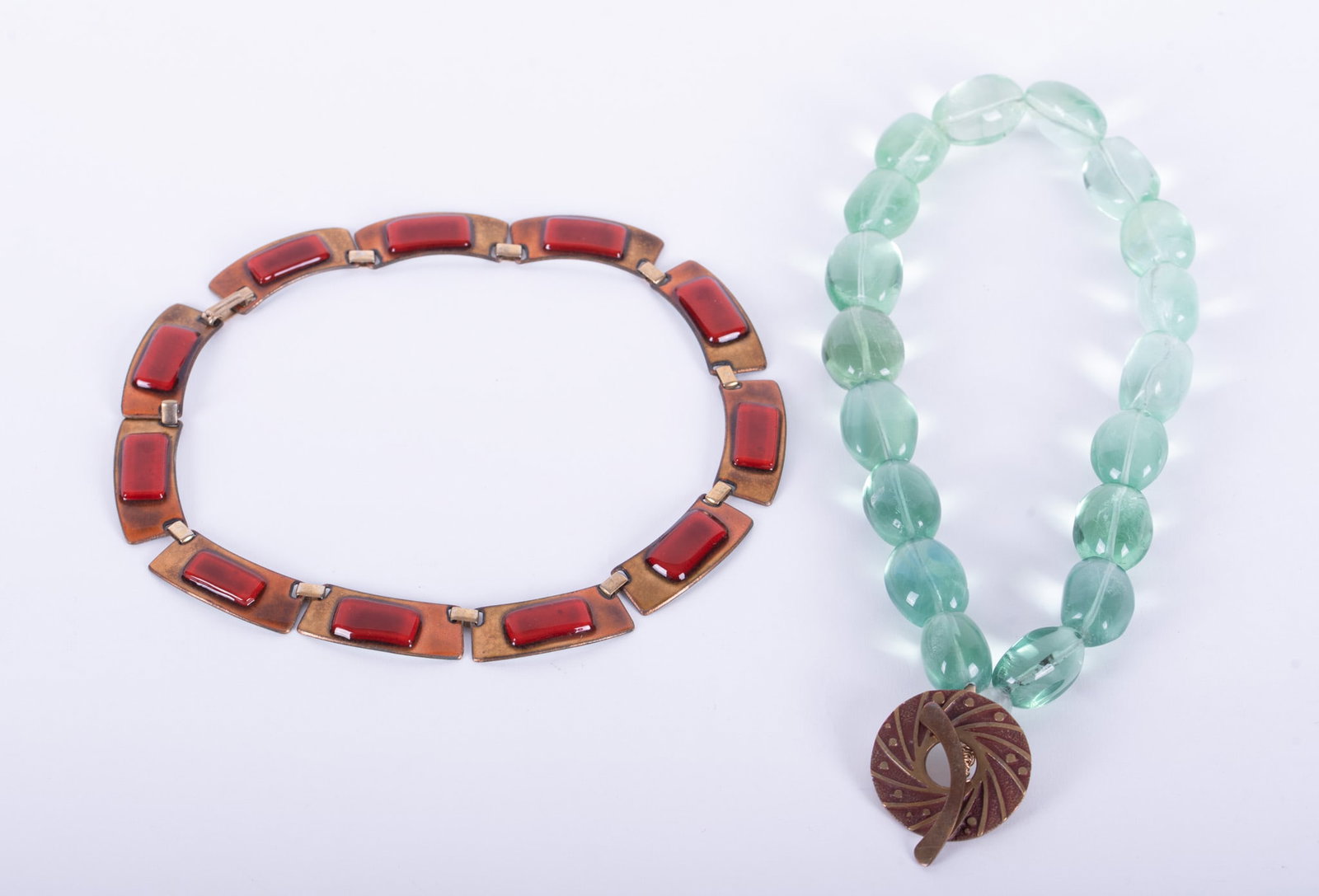 Vintage Modernist Kay Denning Enamel and Copper Choker together with Green Glass Bead Choker with: Key Denning choker/necklace, signed, white enamel on reverse, length 14 inches; together with large light green glass bead choker with designed Saki bronze clasp, diameter 1 1/4 inches, choker length 