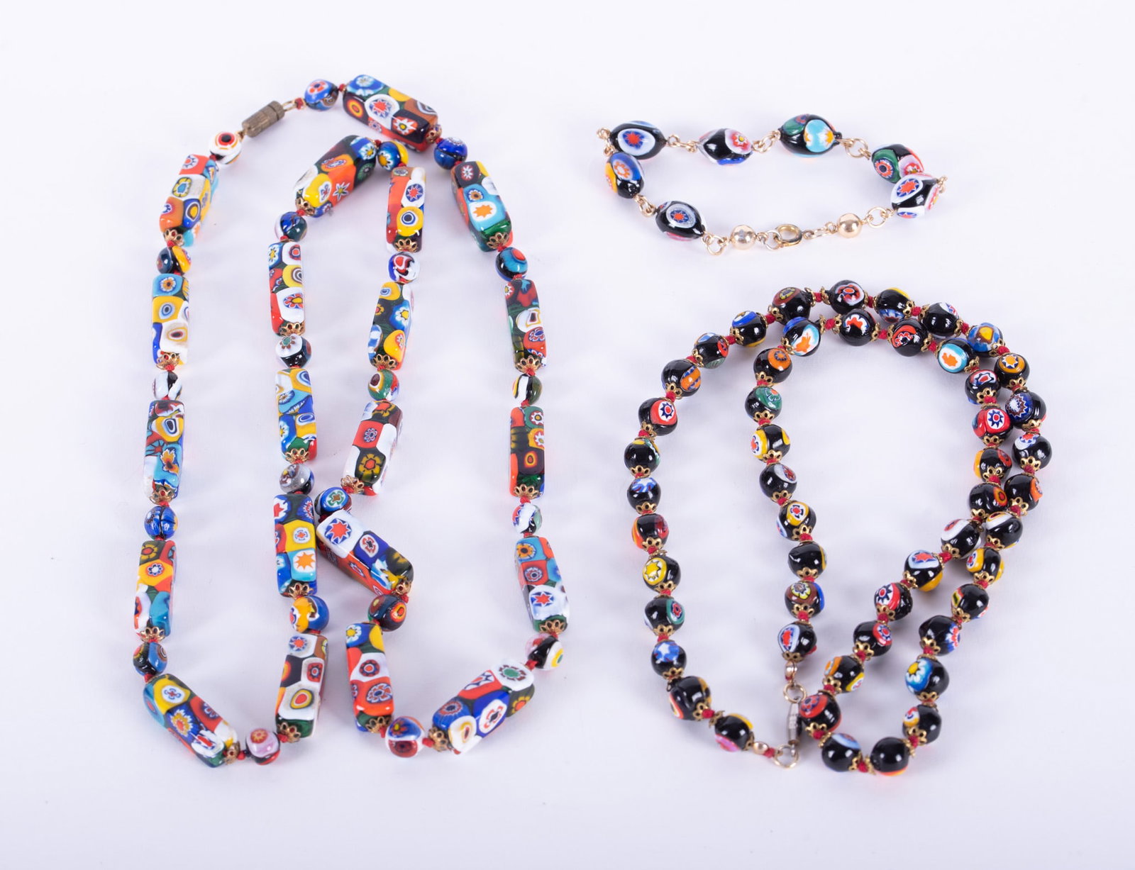 Two Italian Murano Millefiori Glass Bead Necklaces Together with One Bracelet: vibrant multi-colors, one with tubular and round beads, length 32 inches; the other round shaped, size approximately 8 to 8 1/2mm, length 24 inches; bracelet with oval shaped beads.