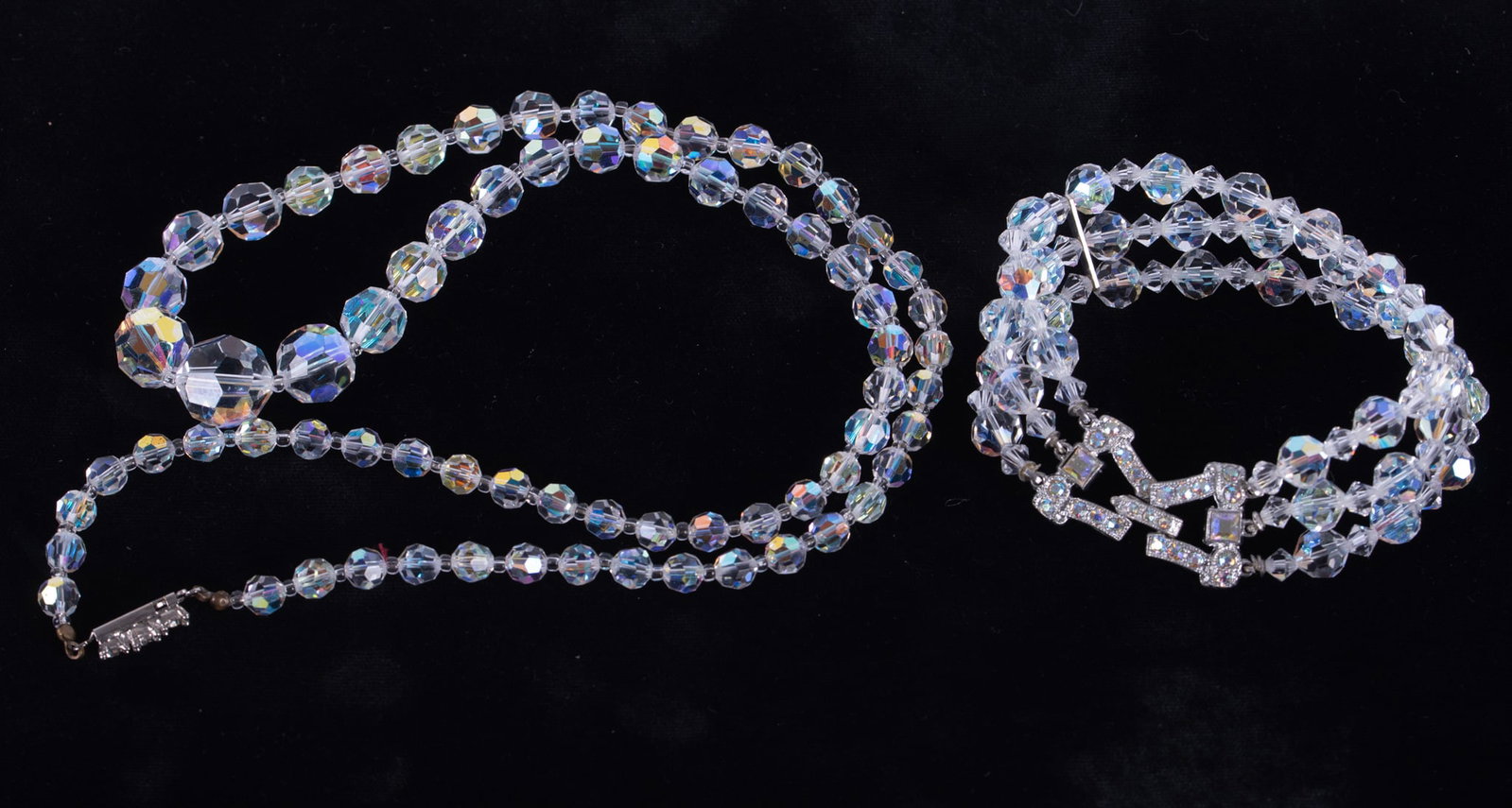 Clear Crystal Graduated Bead Necklace together with Three Strand Bracelet and Rhinestone Clasp: the vintage necklace with rhinestone clasp, length 24 inches; the bracelet with large ornate rhinestone clasp. (2 pieces)