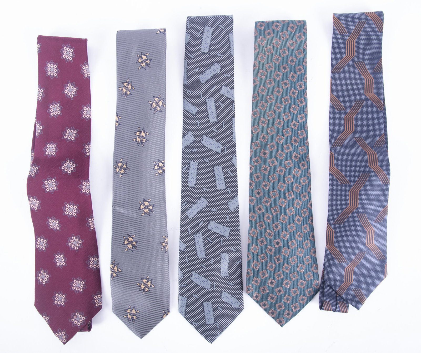 Group of Five Giorgio Armani Designer Silk Ties: one bluish/green background with square design; one burgundy background with square designs, marked Made in Italy; Grey stripes with gold pattern design; Grey/black striped with rectangle shape