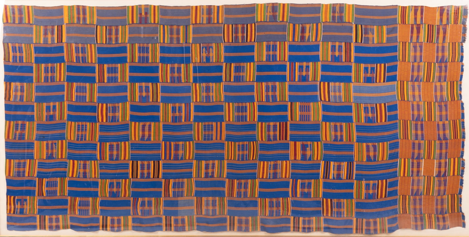A Vintage Asante Woman's Kente Cloth: mounted and framed in a shadowbox.