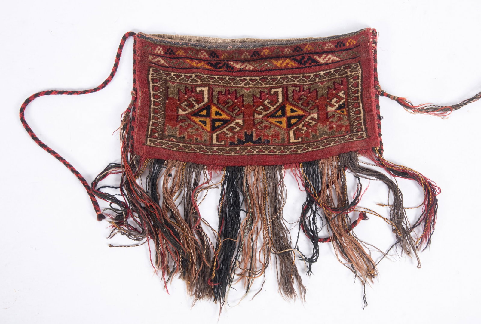 Antique Tekke Bag: Nomadic tribes used for storing and transporting household goods, clothing, and food within their portable yurts. Hand woven wool with cords, pocket for storage.